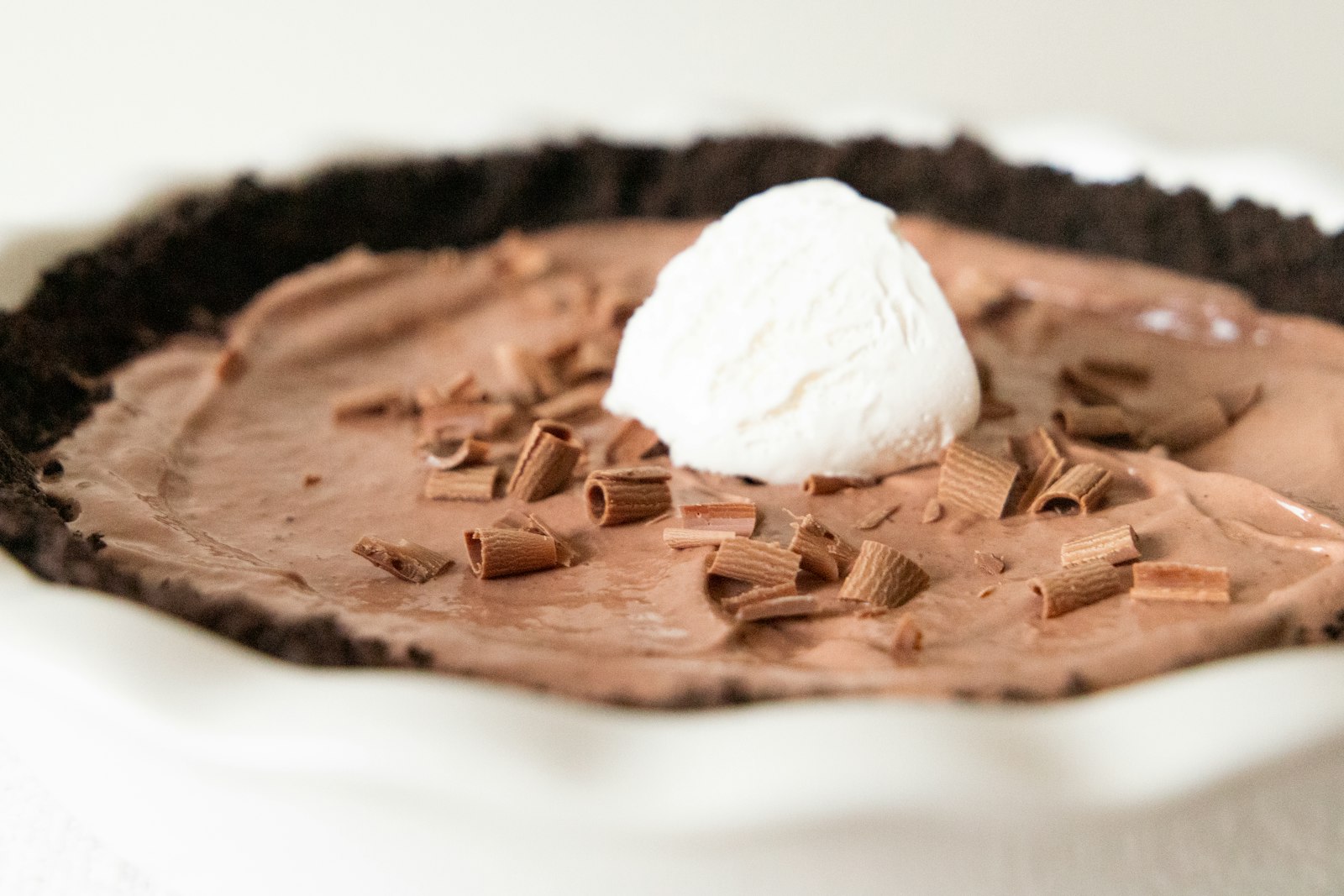 Chocolate mud pie with whipped cream and chocolate curls