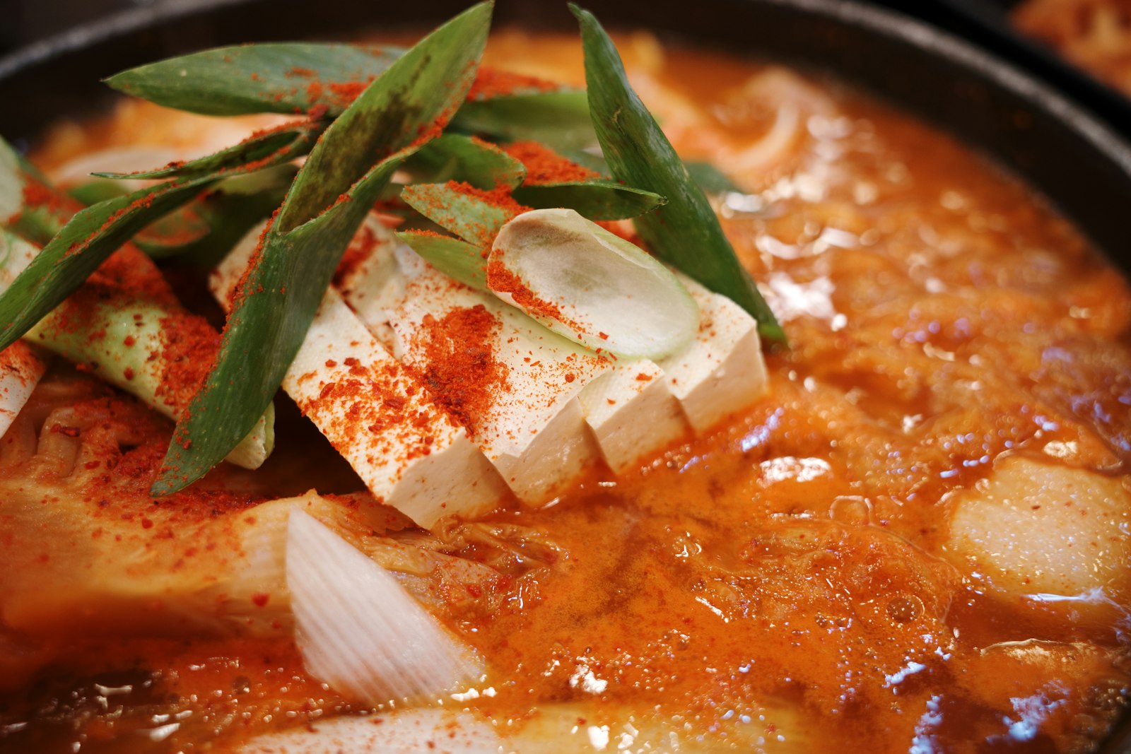 Red kimchi stew with tofu and green onion