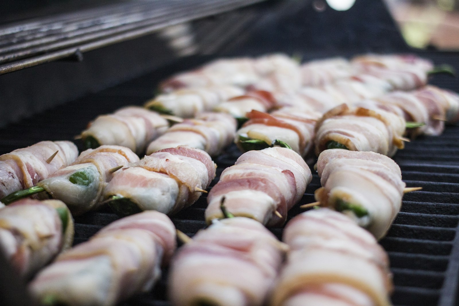 Spicy dishes: bacon wrapped jalapeno poppers on a grill