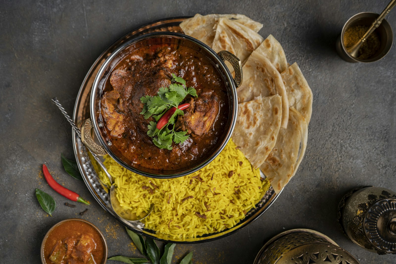 Spicy dishes: dark red vindaloo curry with rice and flatbread