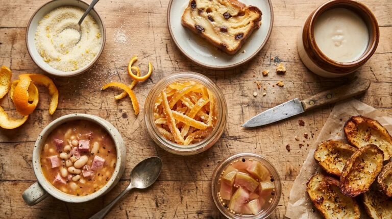 Kitchen scraps flat lay with candied orange peel, bread pudding, ham and bean soup and pickled watermelon rind