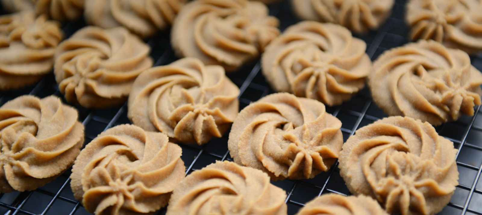 Piped lunch lady butter cookies cooling on a rack