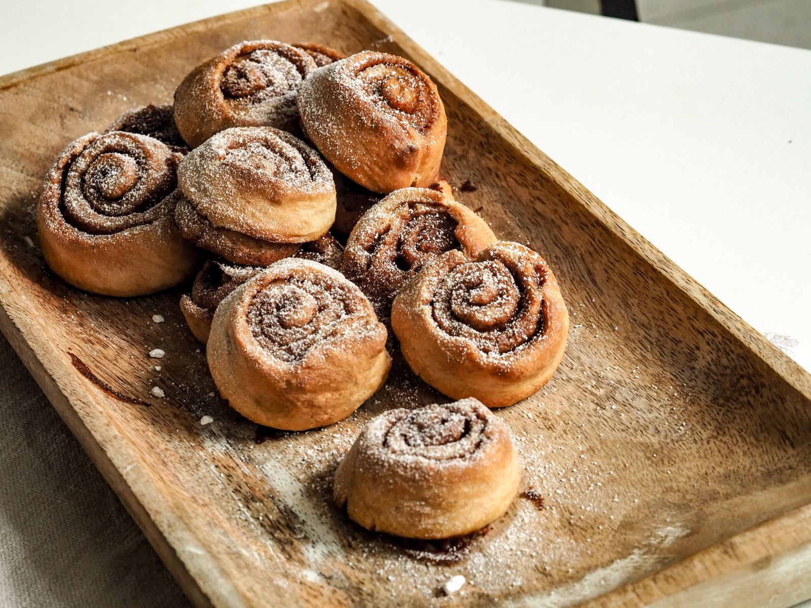 Homemade cinnamon rolls on a wooden tray