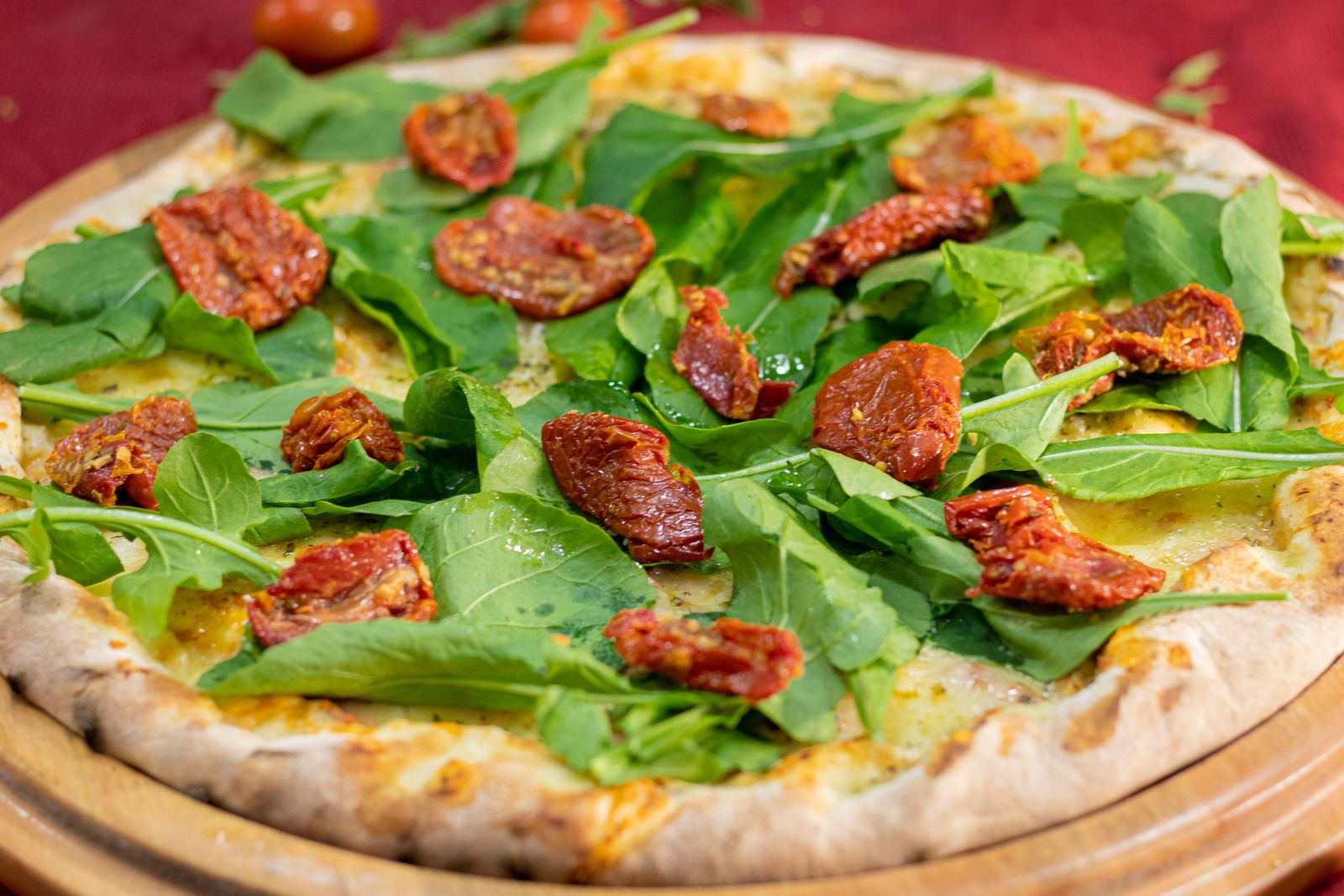 Flatbread pizza with sun dried tomatoes and greens