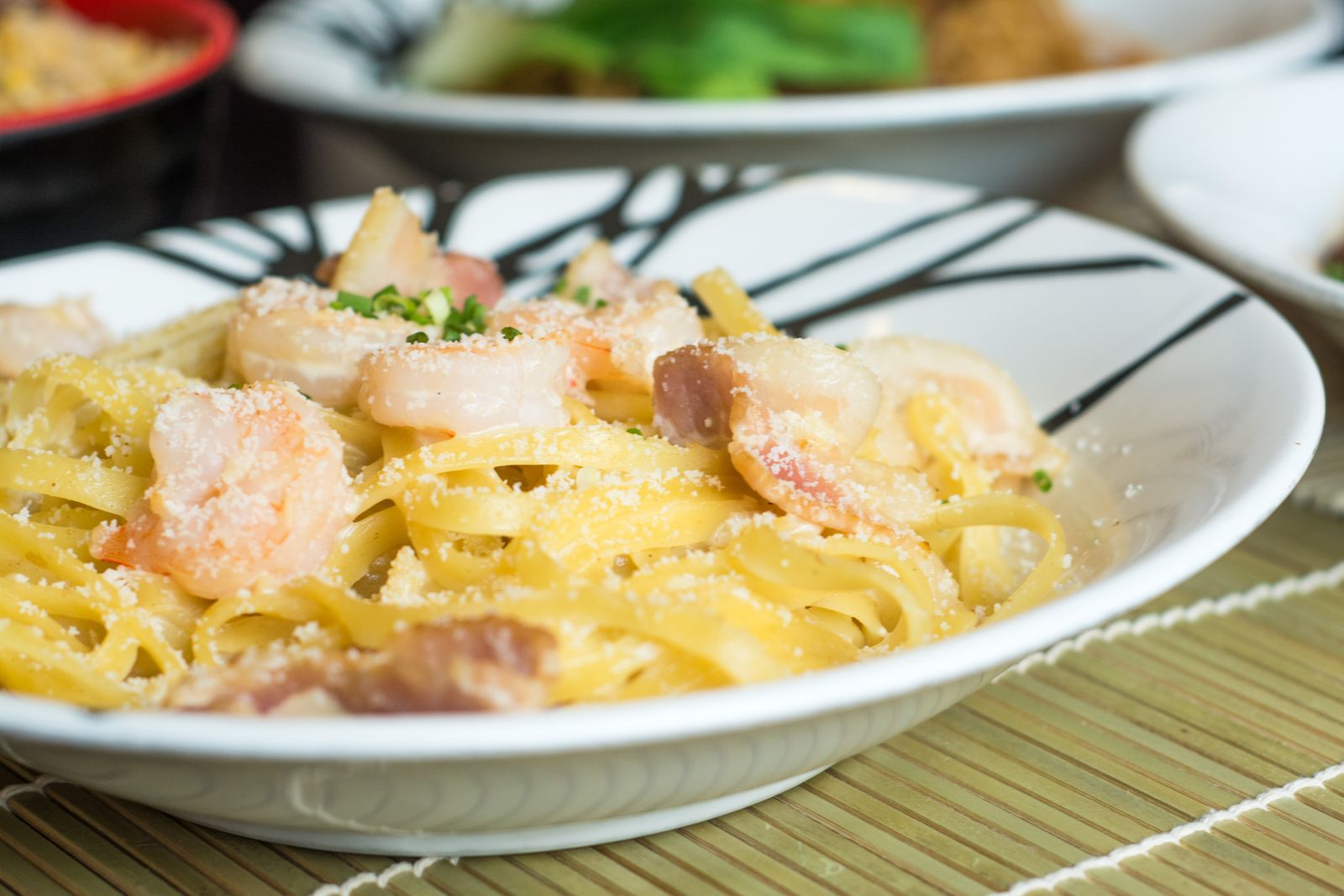 Creamy shrimp pasta in a white bowl
