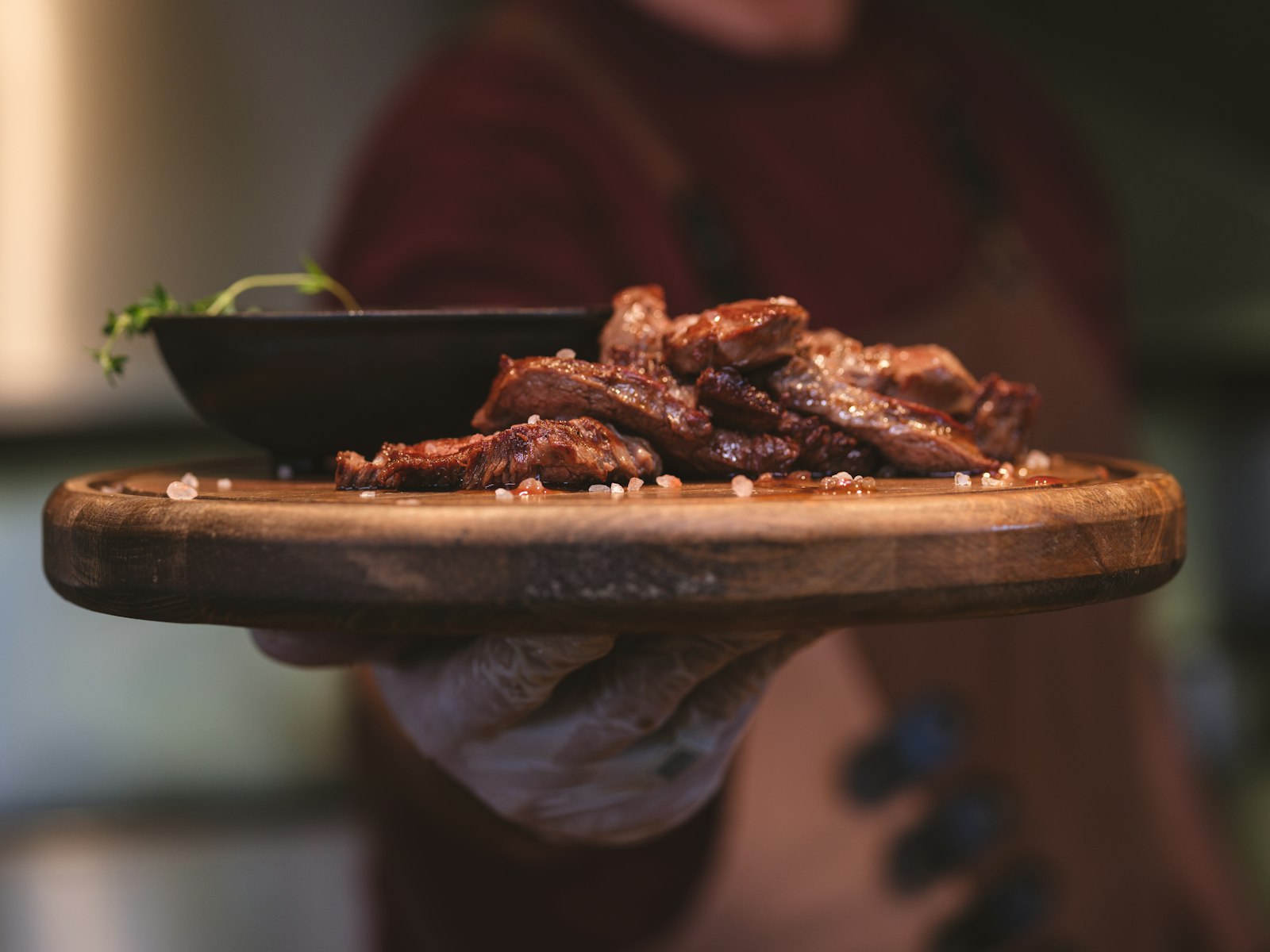 Seared steak bites on a wooden board
