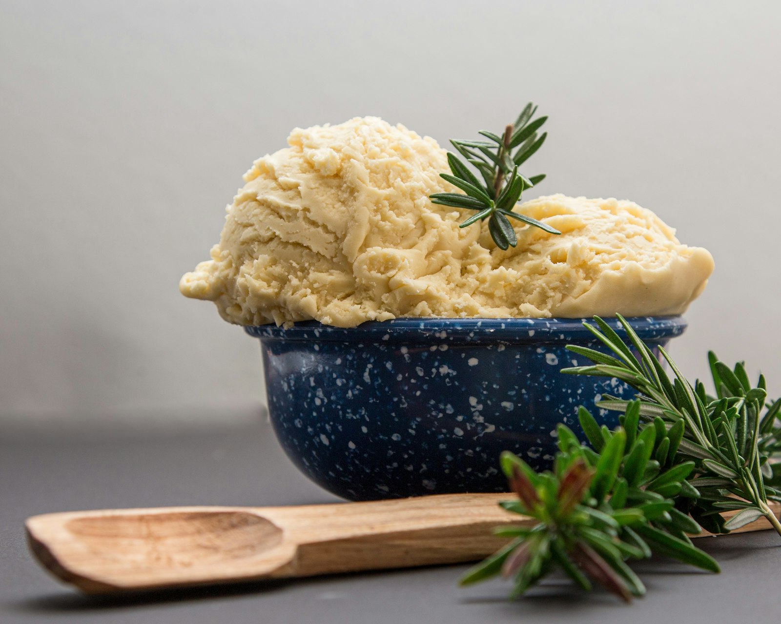 Roasted garlic mash in a blue pot with rosemary