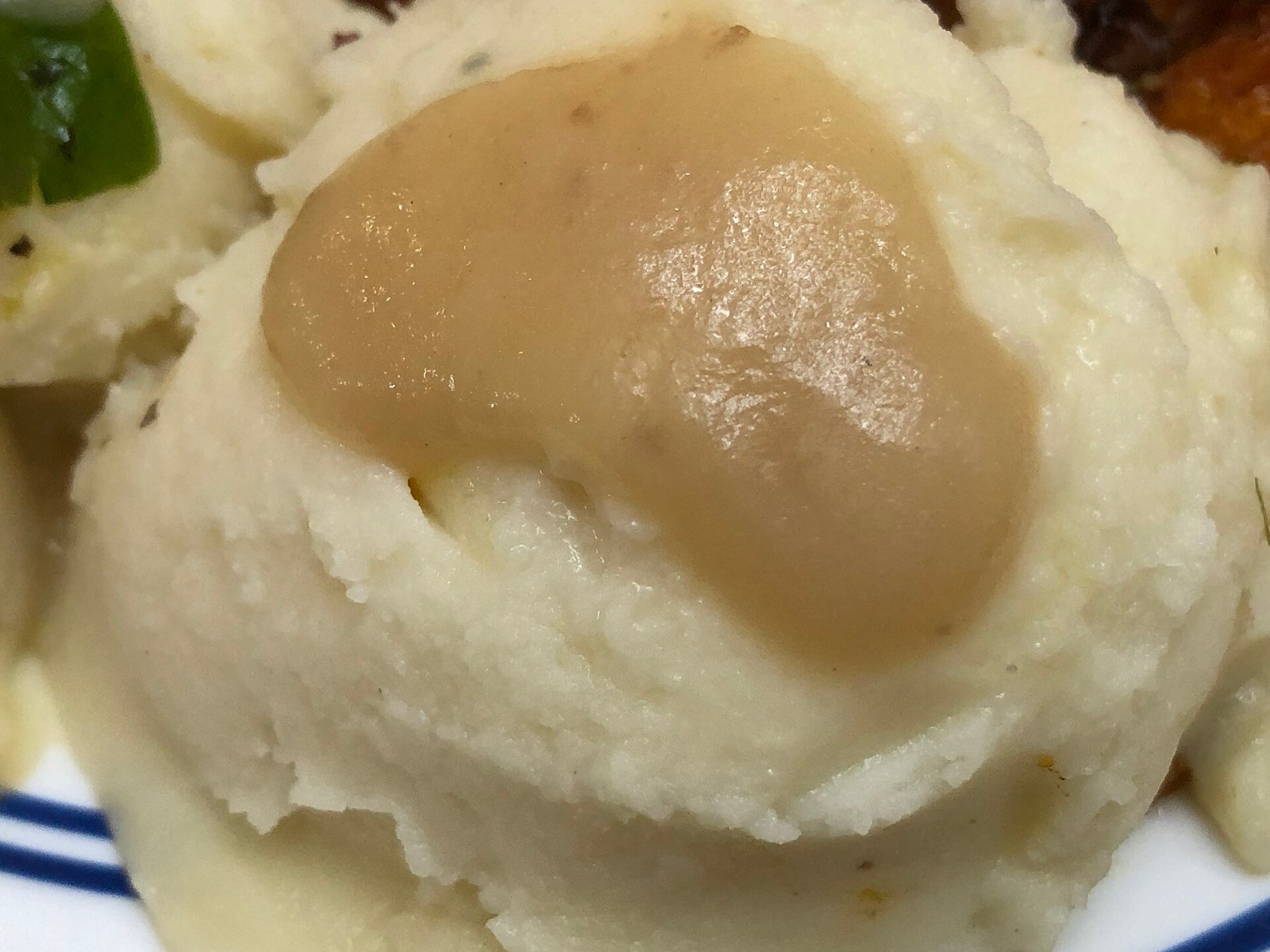 Mashed potatoes topped with a pool of brown gravy