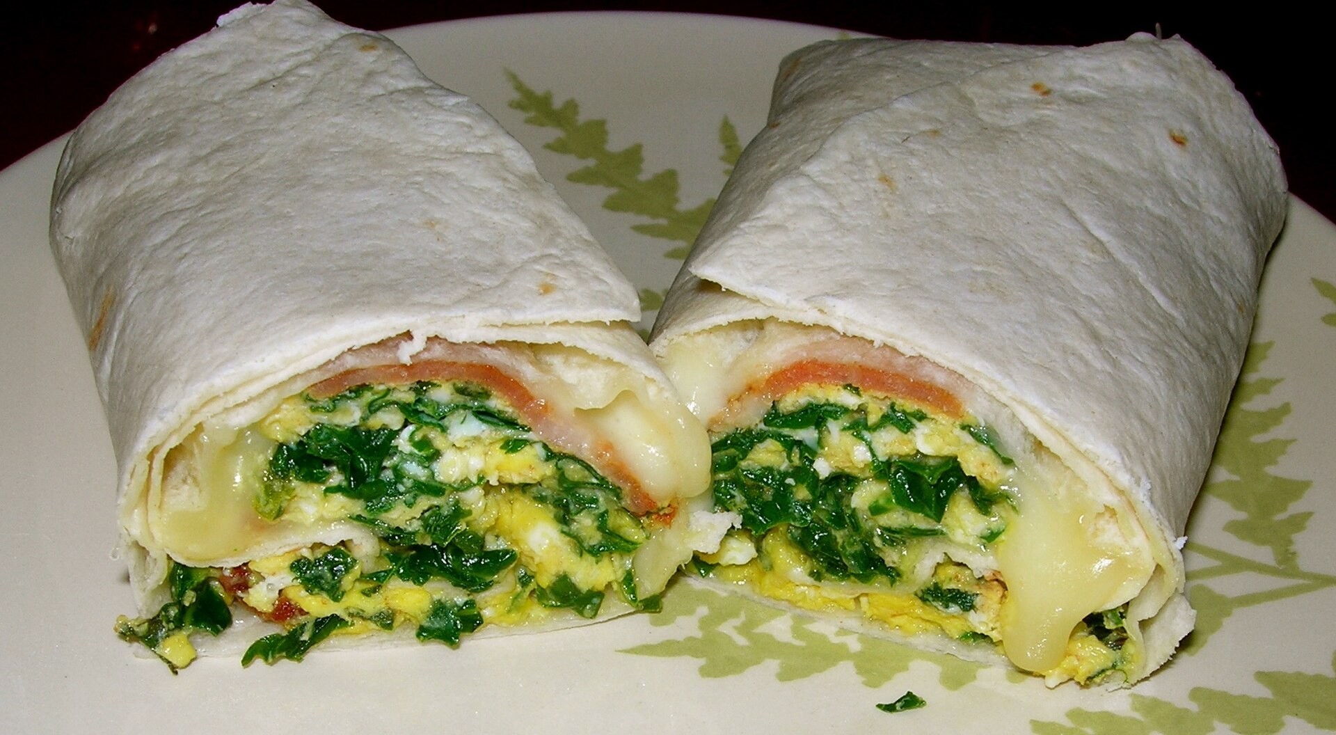 Egg and spinach breakfast burrito cut in half