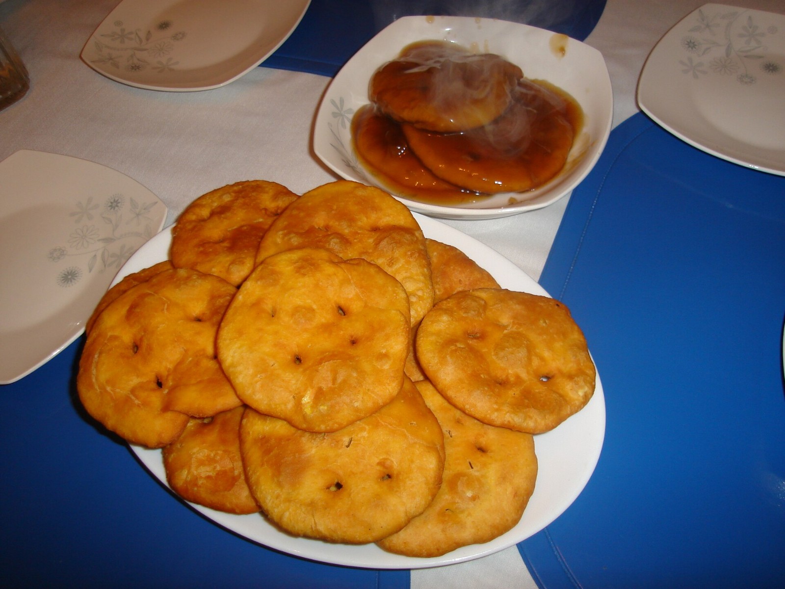 Orange Chilean pumpkin sopaipillas on a white plate