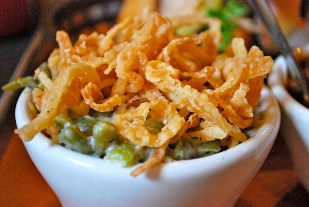 Homemade crispy fried onions piled high on a creamy side dish