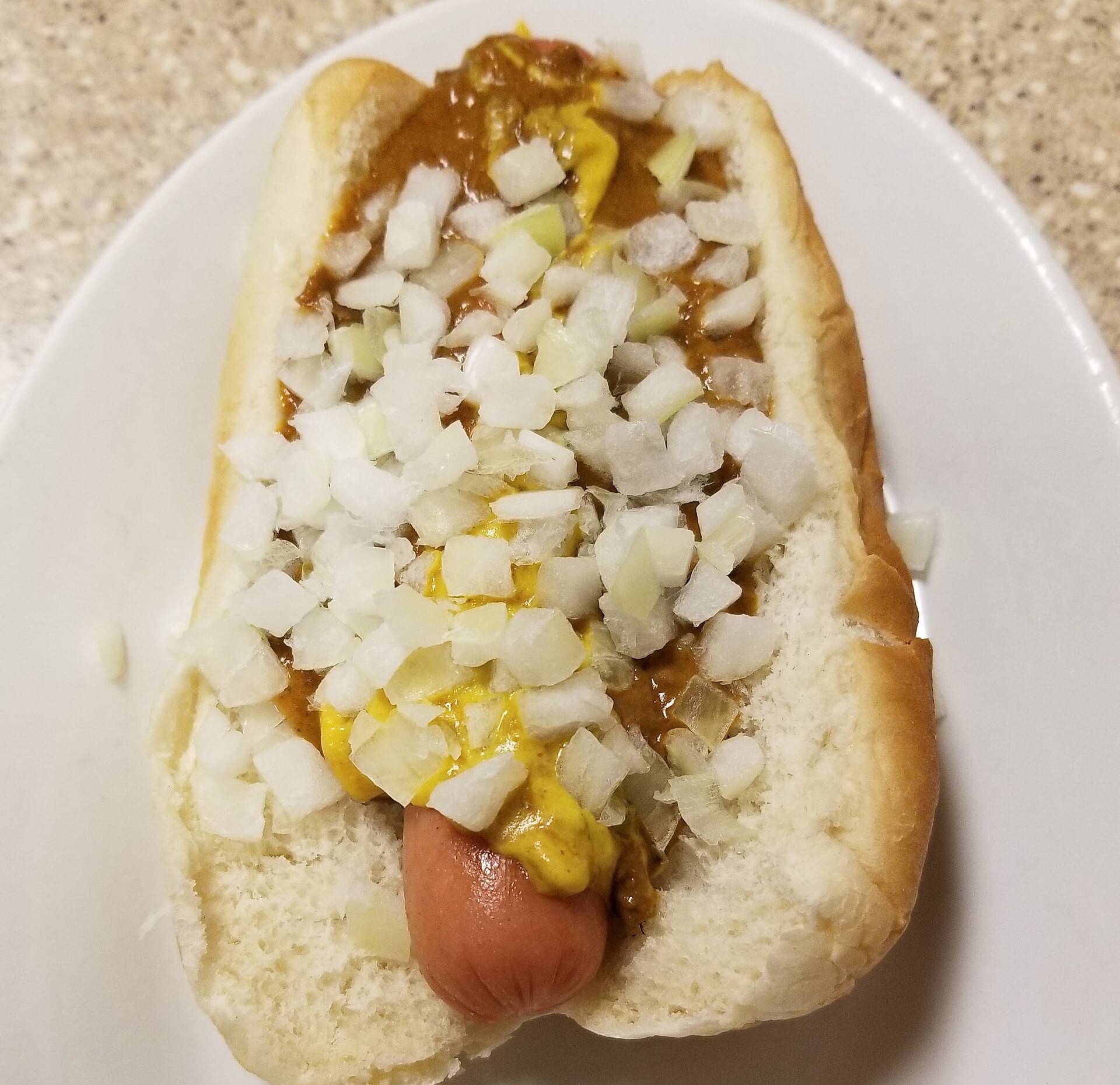 Detroit coney dog with chili sauce, mustard and chopped onion