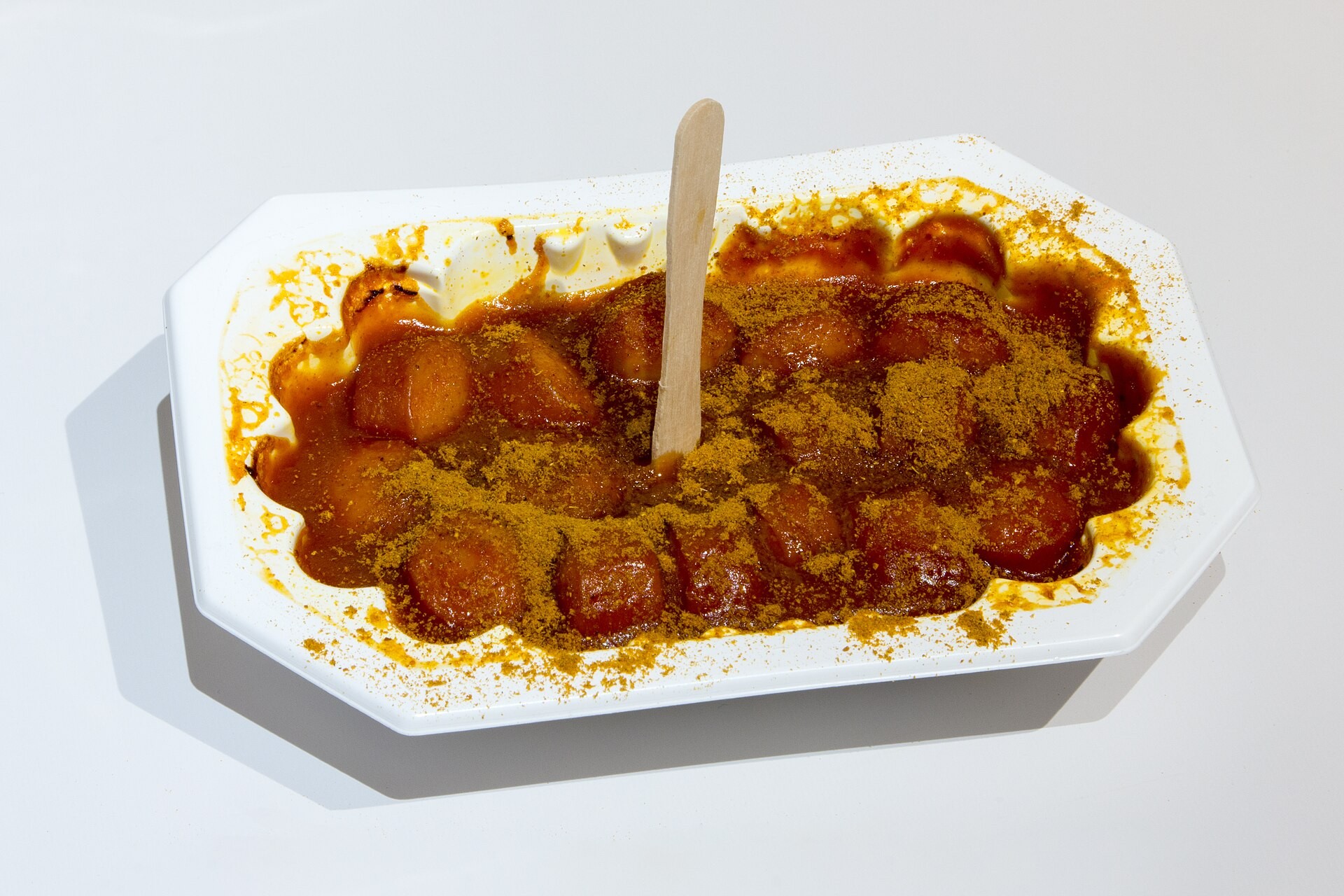 Currywurst, sliced sausage in curry ketchup sauce in a paper tray