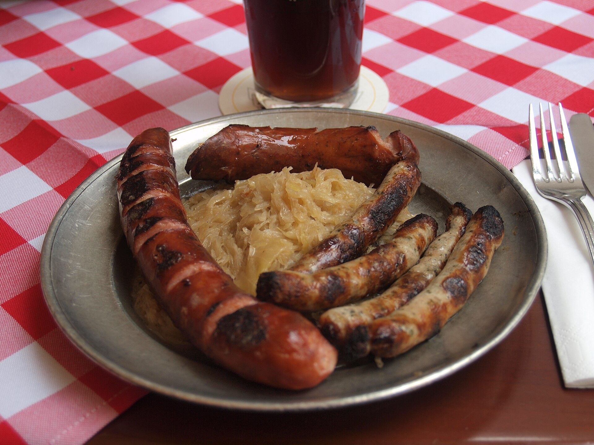 Grilled sausages served on a bed of sauerkraut