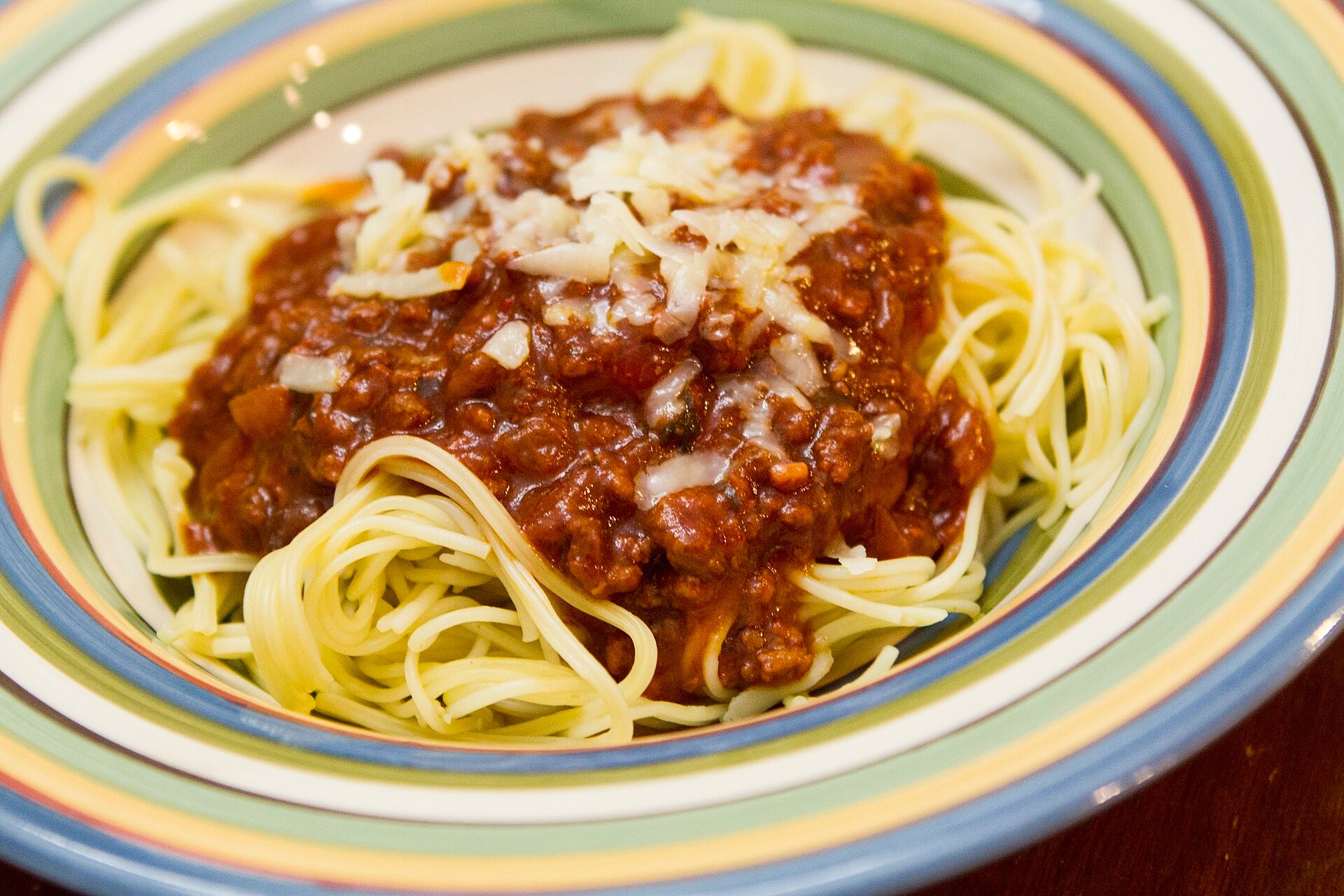 Filipino-style sweet spaghetti with meat sauce and grated cheese