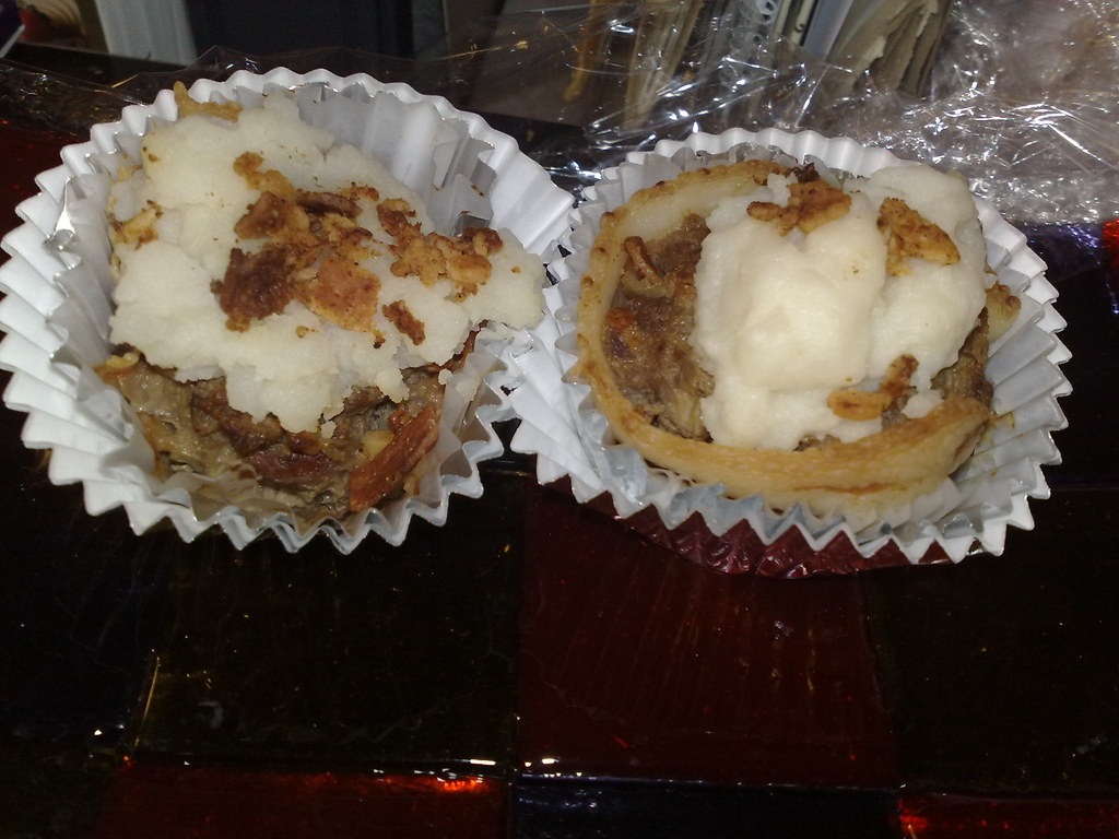 Meatloaf cupcakes topped with mashed potato frosting and crispy bacon bits