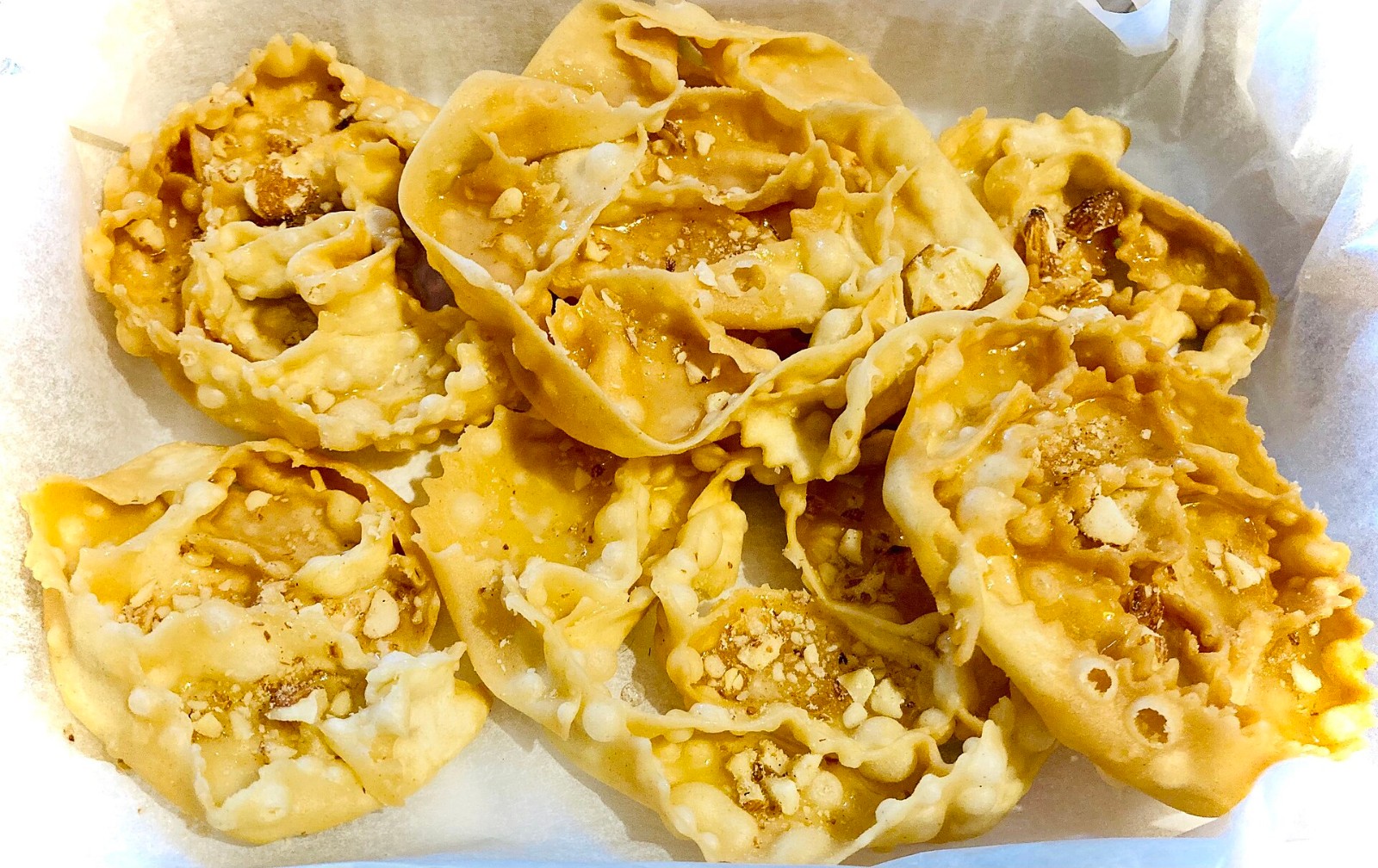 Rose shaped cartellate pastries from Puglia glazed with honey and nuts