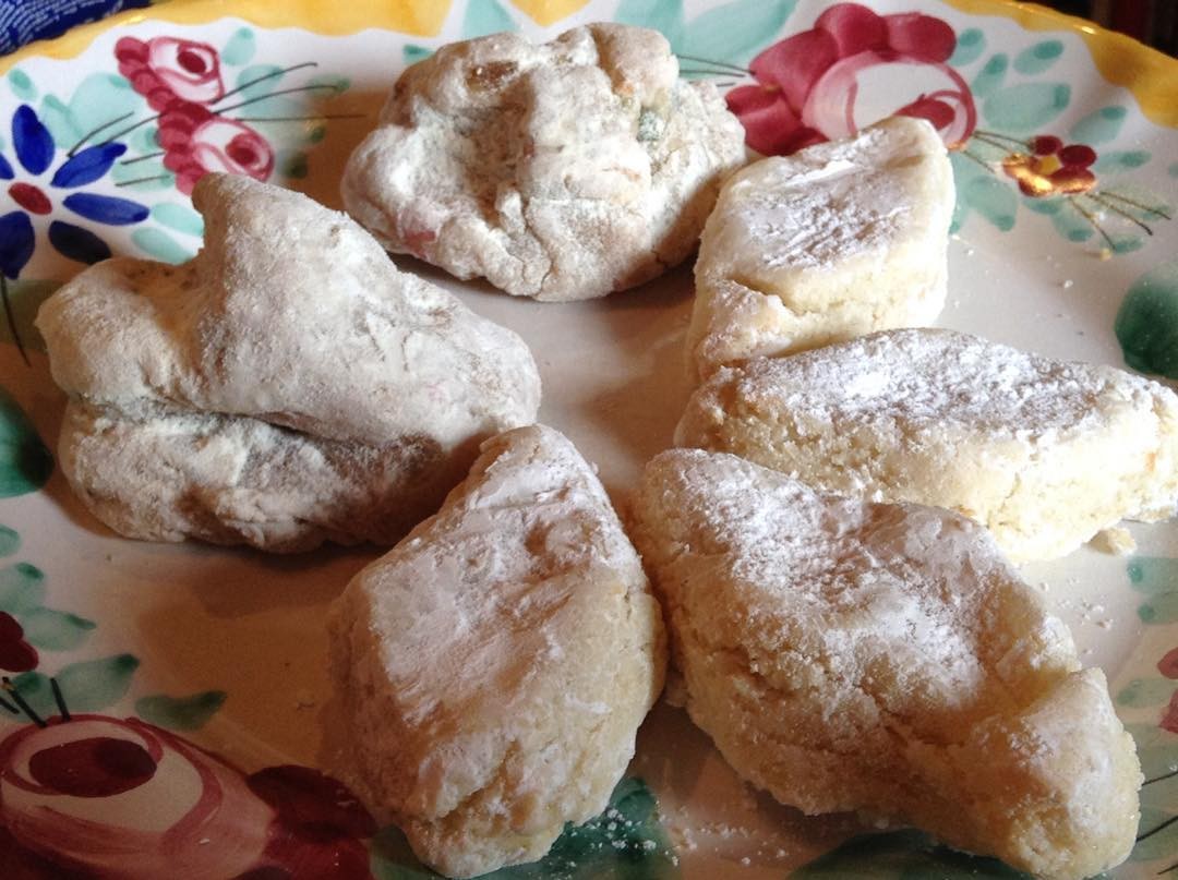 Floury white cavallucci honey walnut cookies on a painted plate