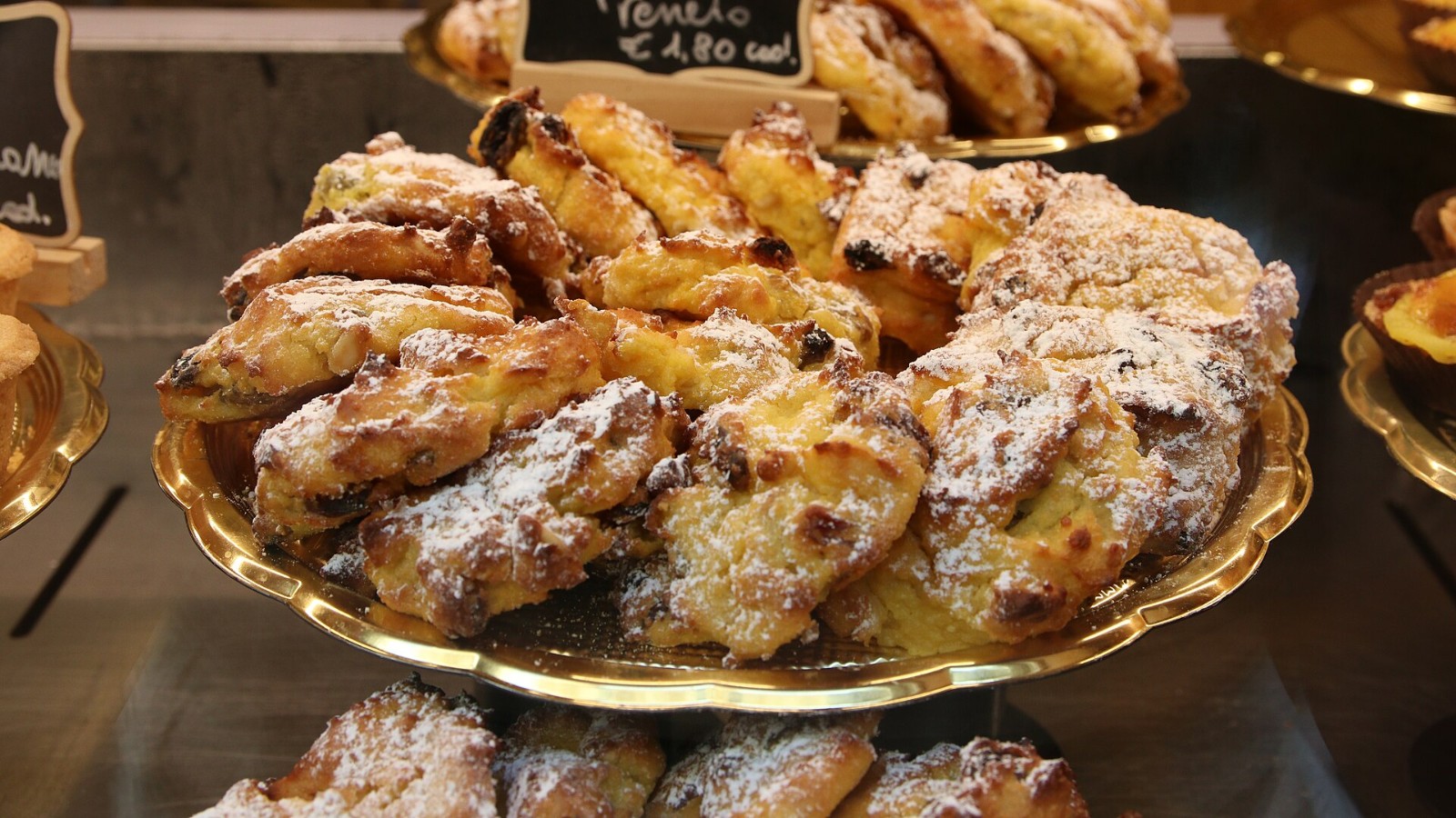 Diamond shaped zaletti cornmeal raisin cookies dusted with powdered sugar