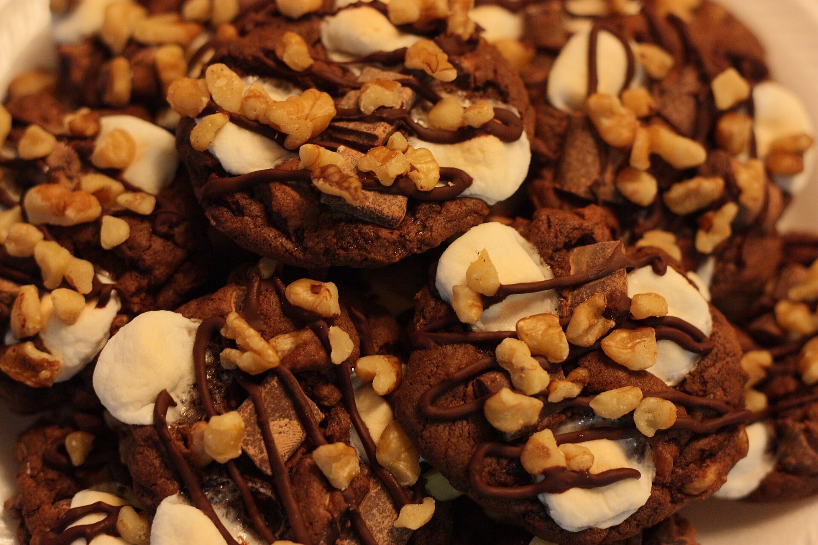Rocky road candy clusters with marshmallows, walnuts and chocolate drizzle