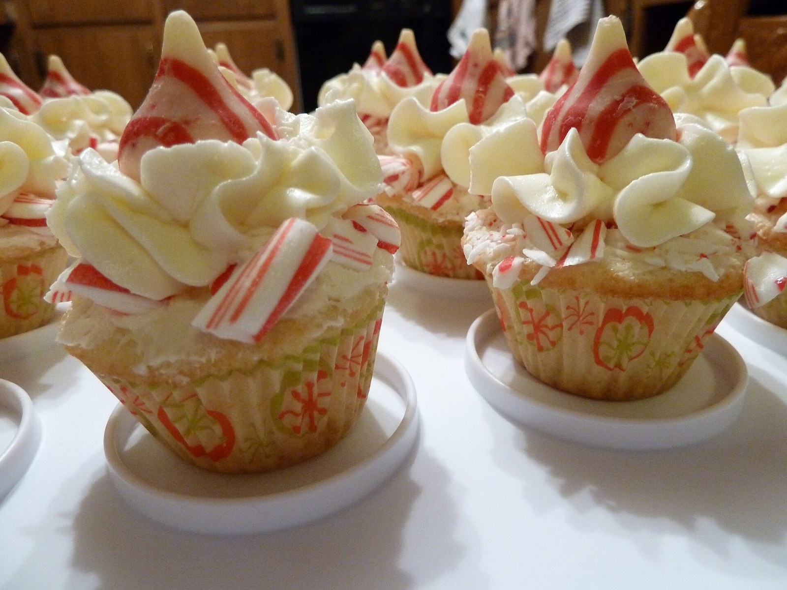 Christmas cupcakes with white swirls and candy cane pieces on top