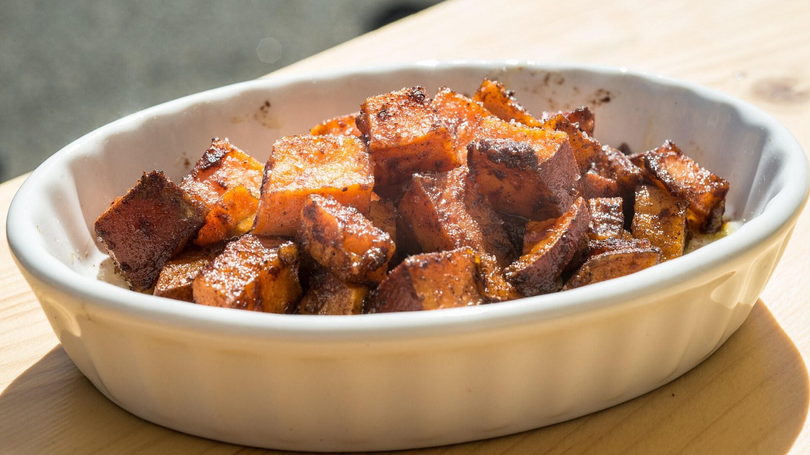 Roasted sweet potato cubes in a white baking dish