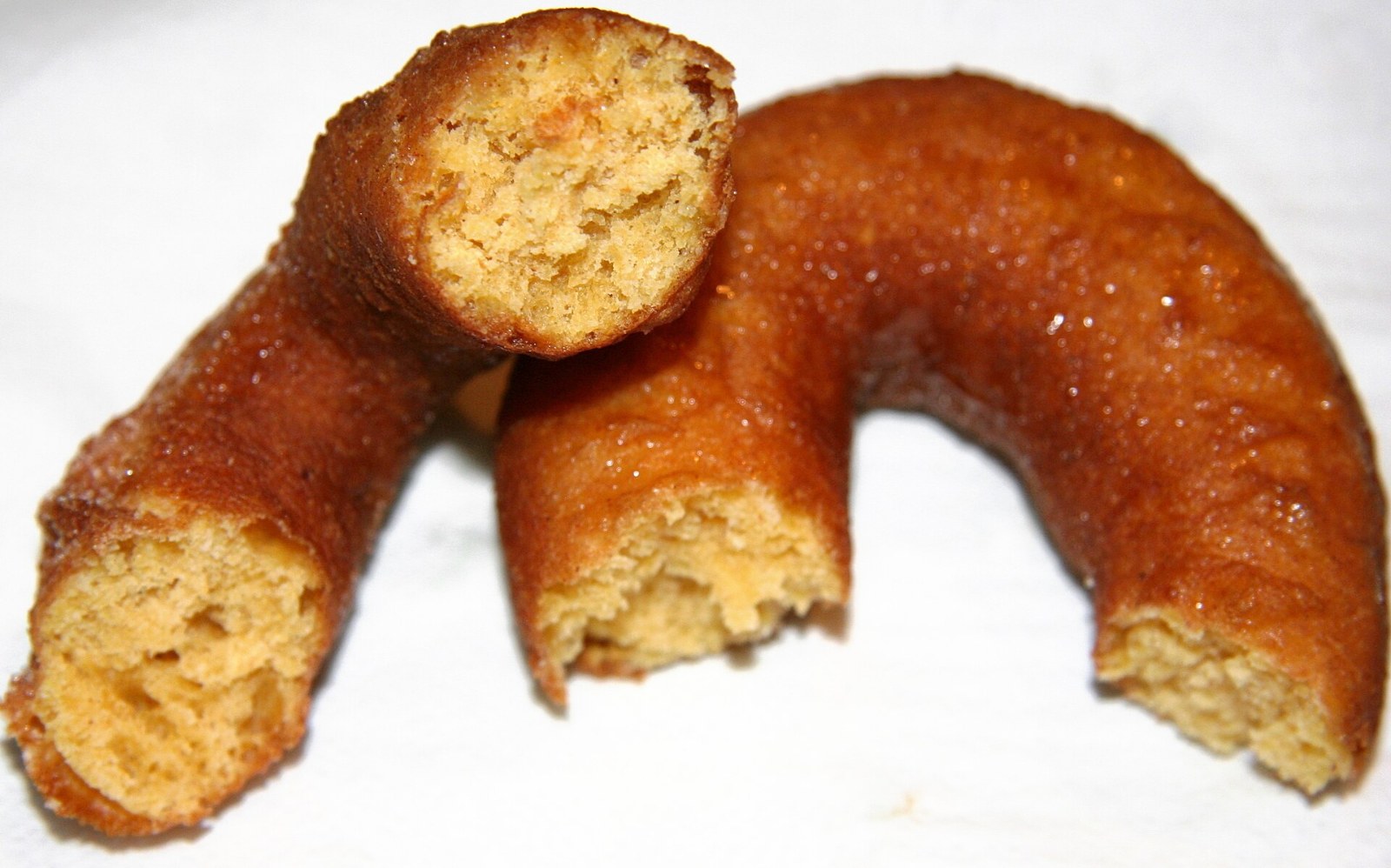 Halves of a cinnamon sugar apple cider donut showing the tender crumb