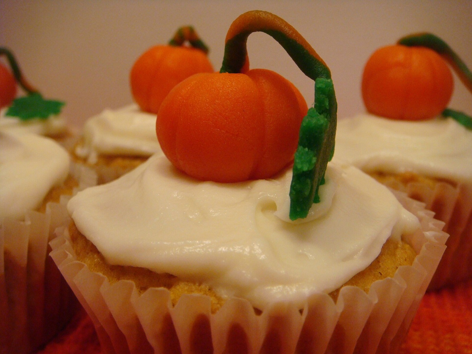 Pumpkin cupcakes with cream cheese frosting and little pumpkin toppers