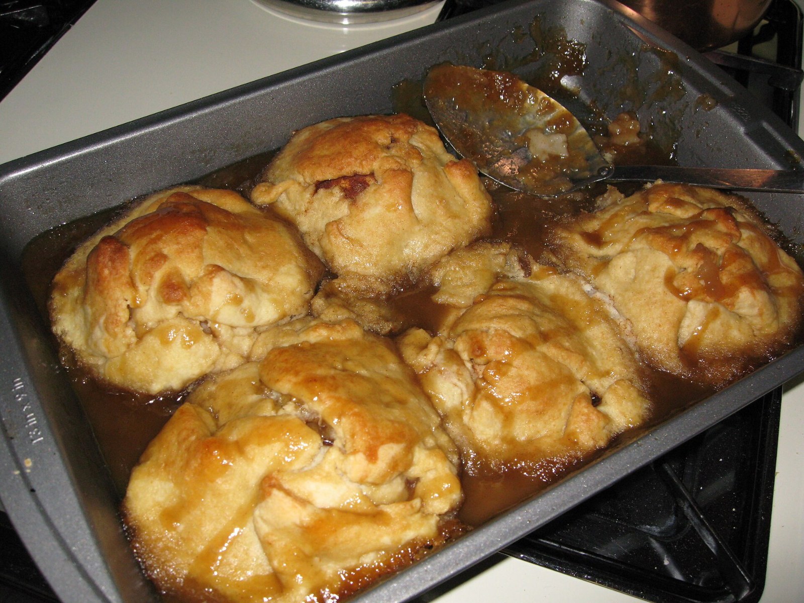 Thanksgiving desserts from grandma: baked apple dumplings in a pan of cinnamon syrup