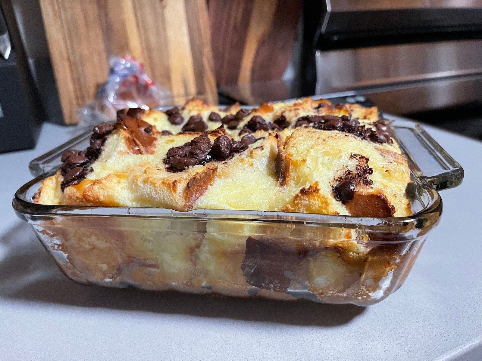Golden baked bread pudding in a glass baking dish