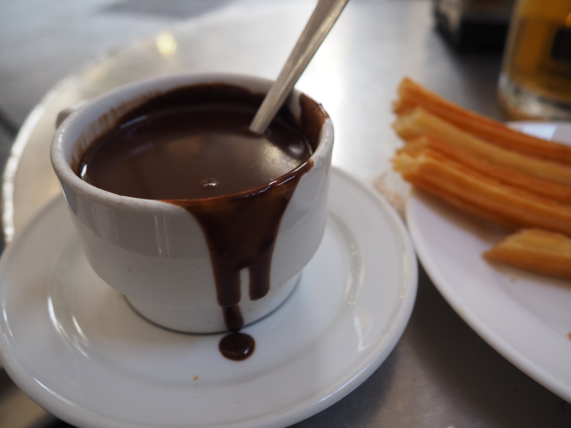 Churros with a cup of thick hot chocolate at a Madrid chocolateria