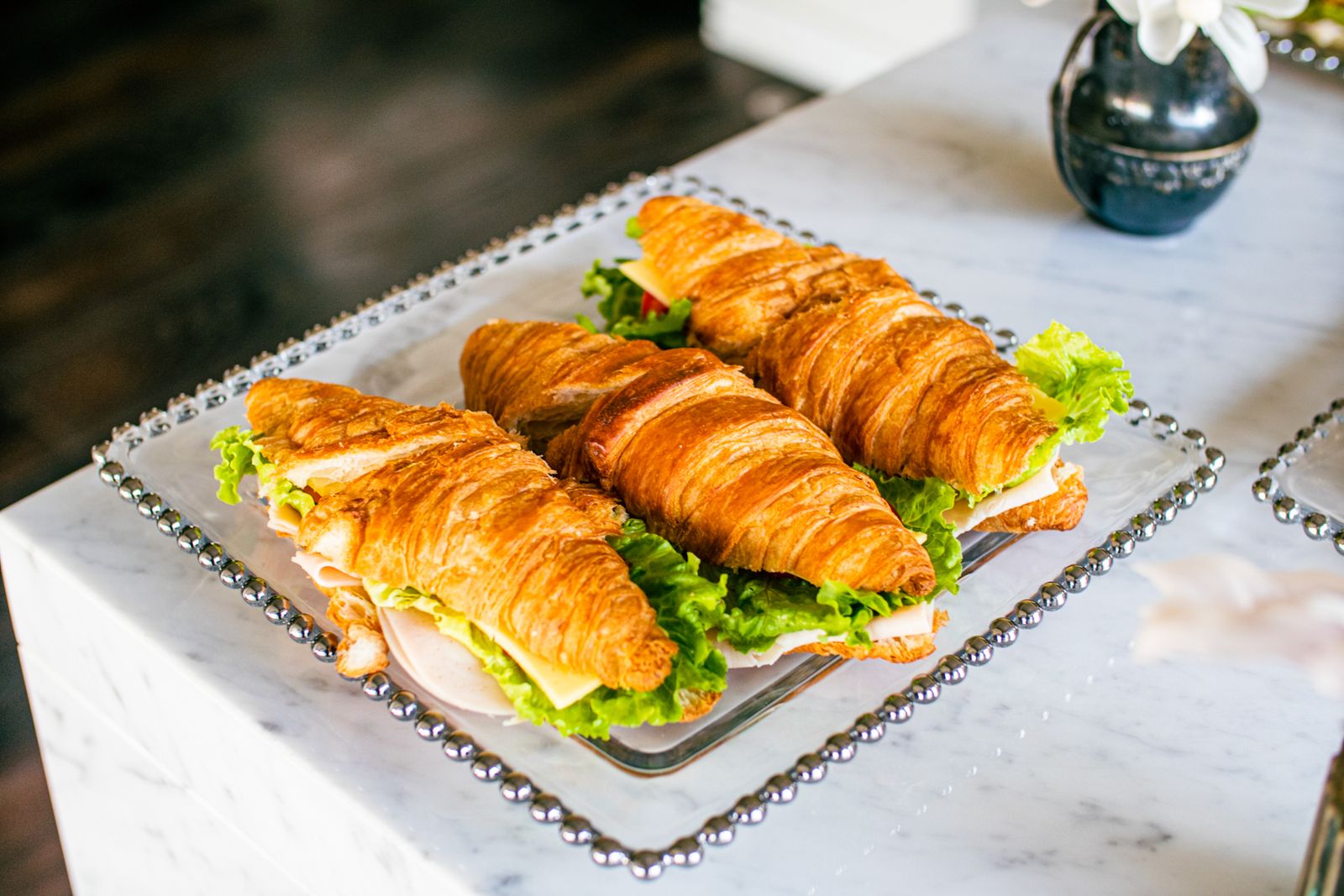 Sandwiches with lettuce on a silver serving tray