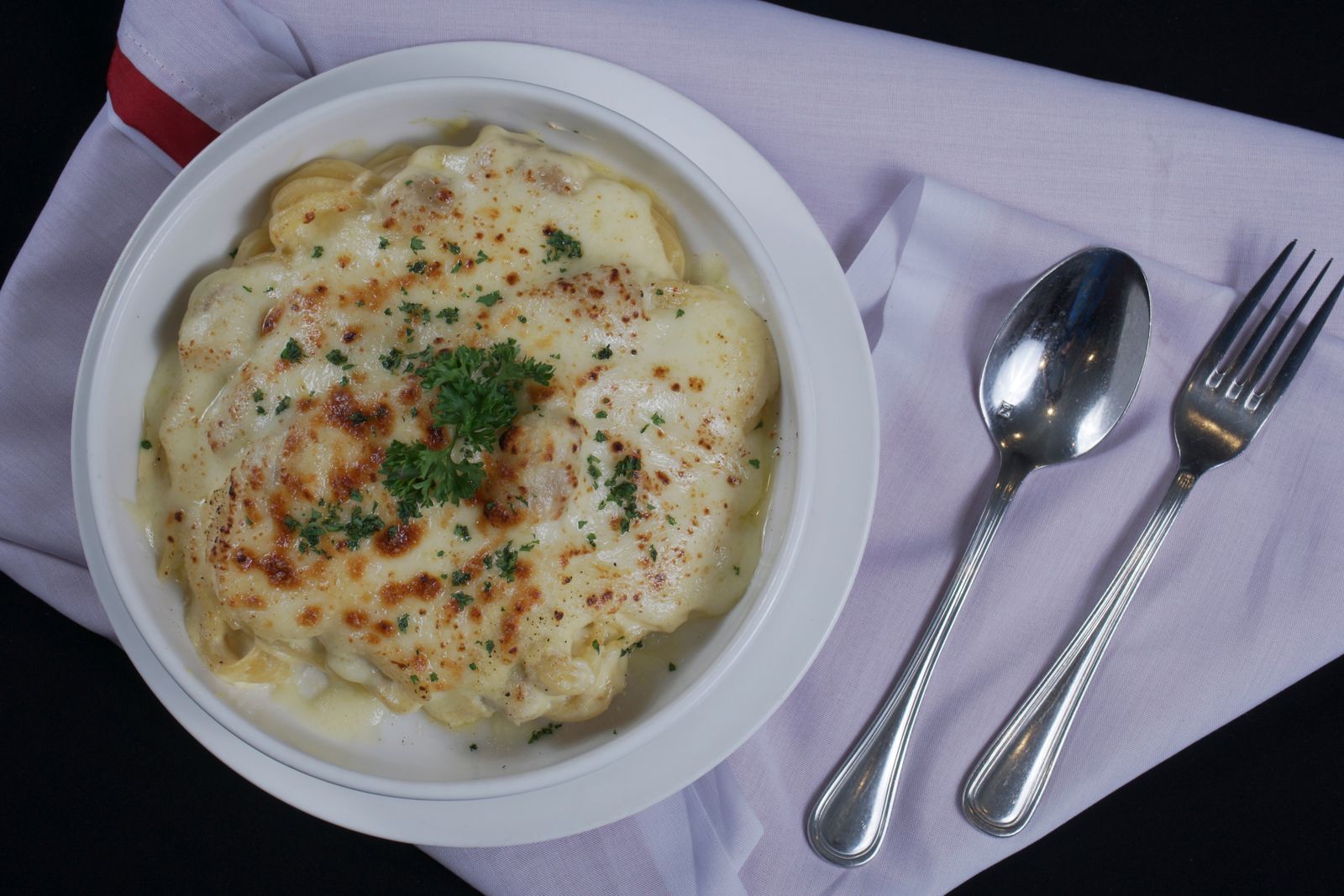 Creamy baked Alfredo pasta in a white dish