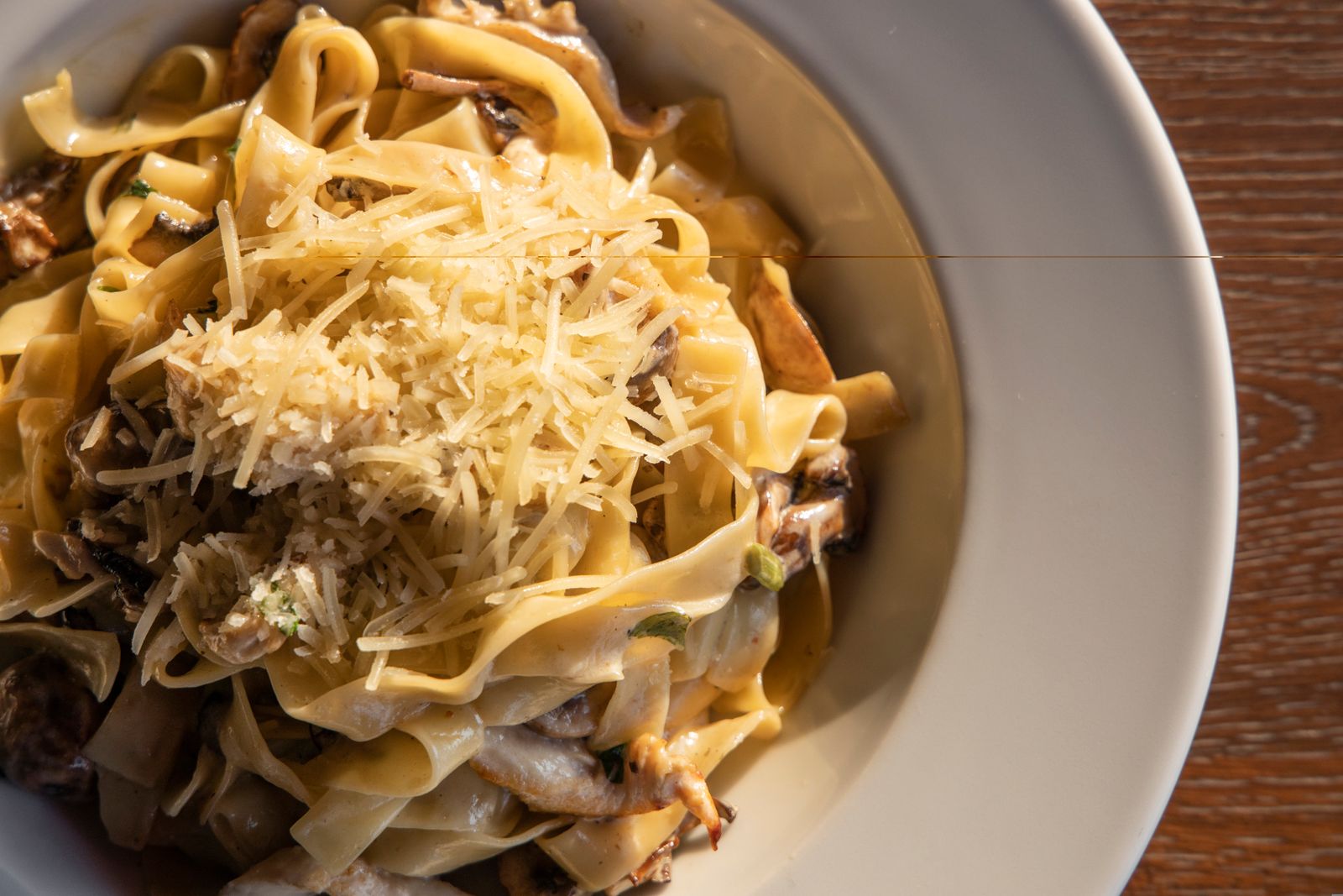 Creamy pasta with Parmesan in a white bowl