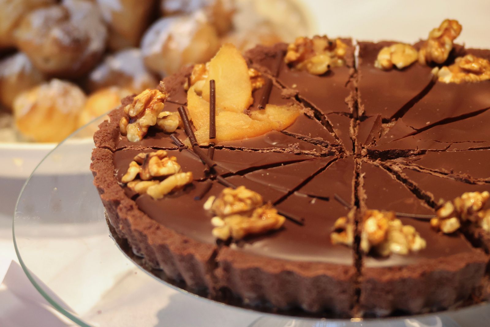 Real chocolate tart with walnuts, cut into slices