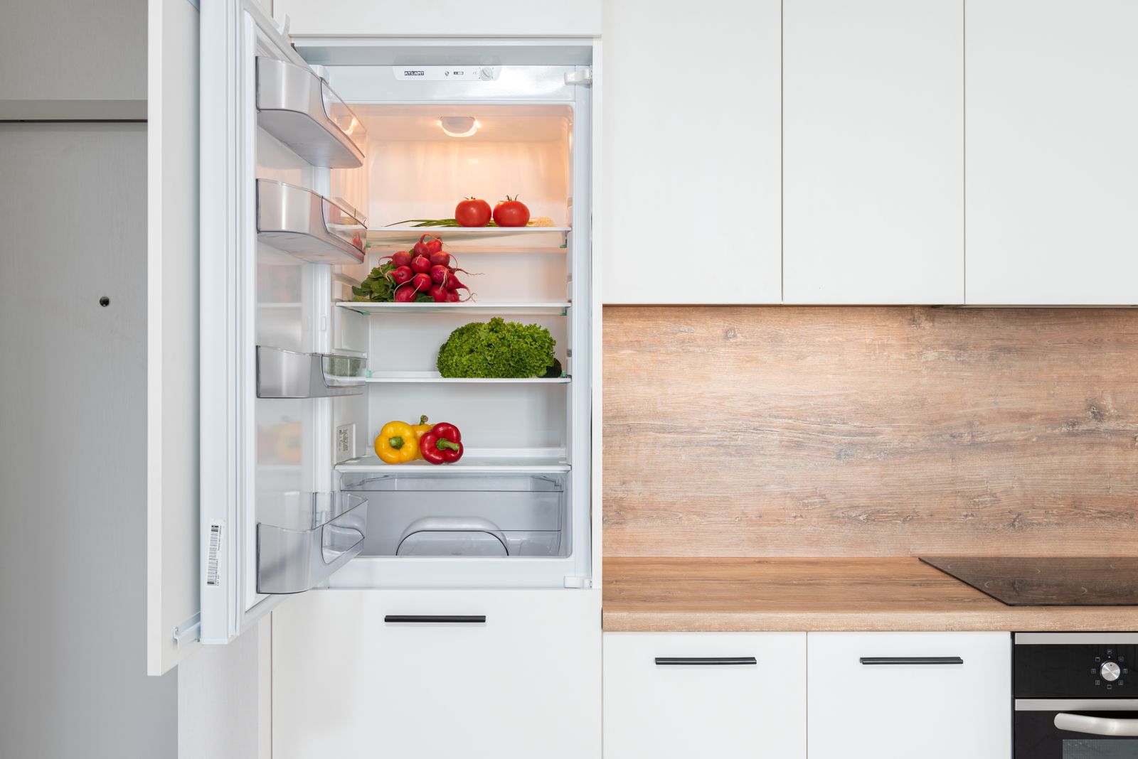 Open fridge in a bright kitchen, ready for labeled leftovers