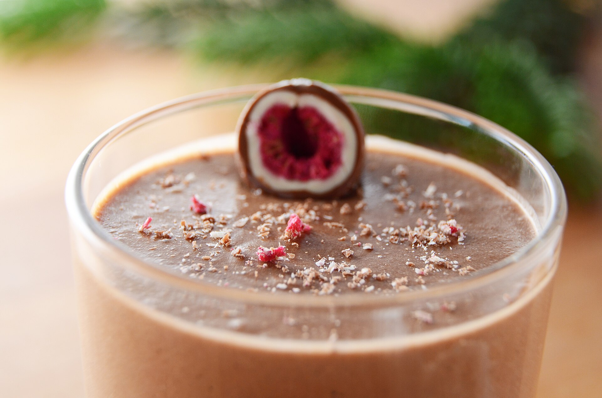 Chocolate mousse in a glass topped with a raspberry