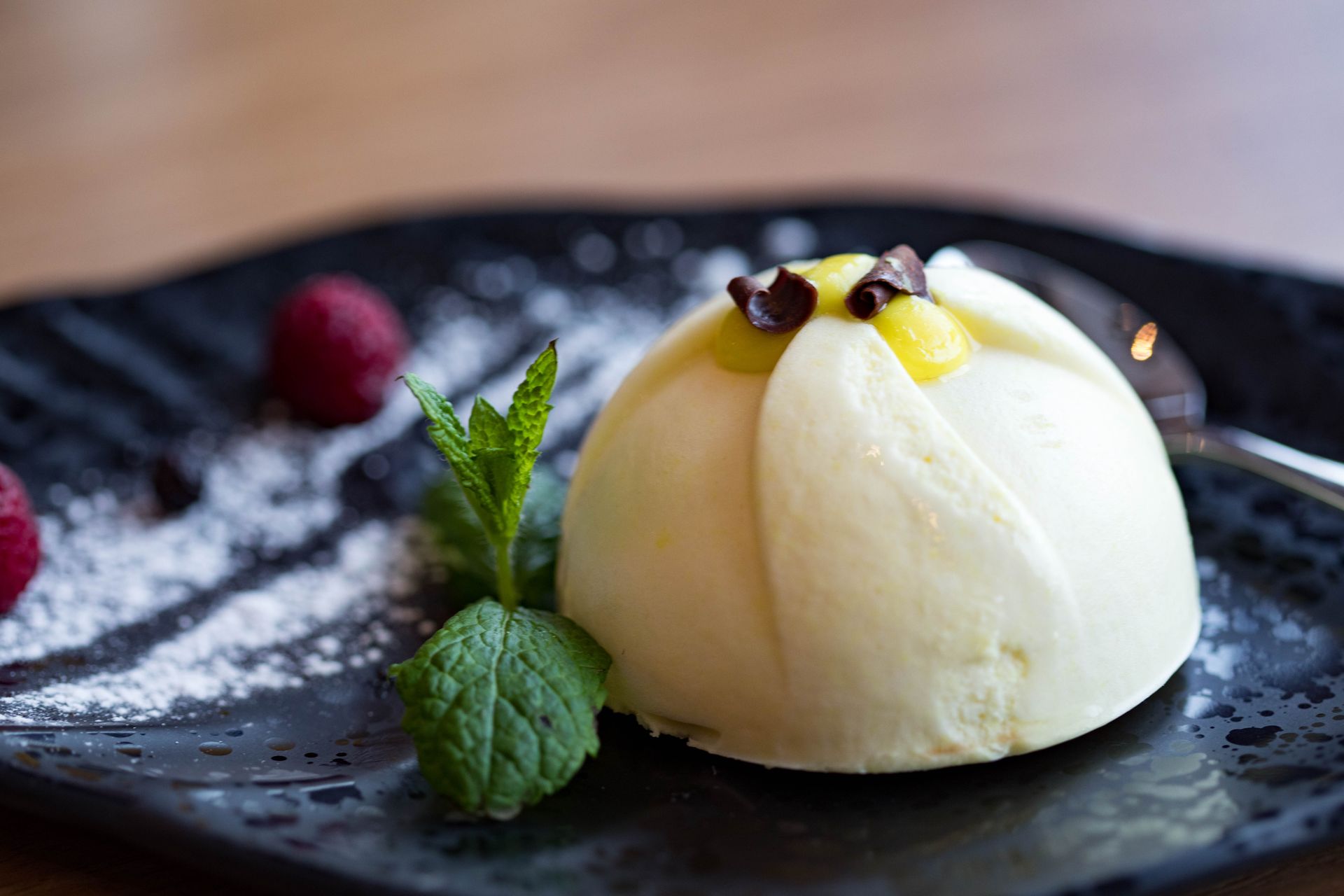 White mousse dome with fresh raspberries