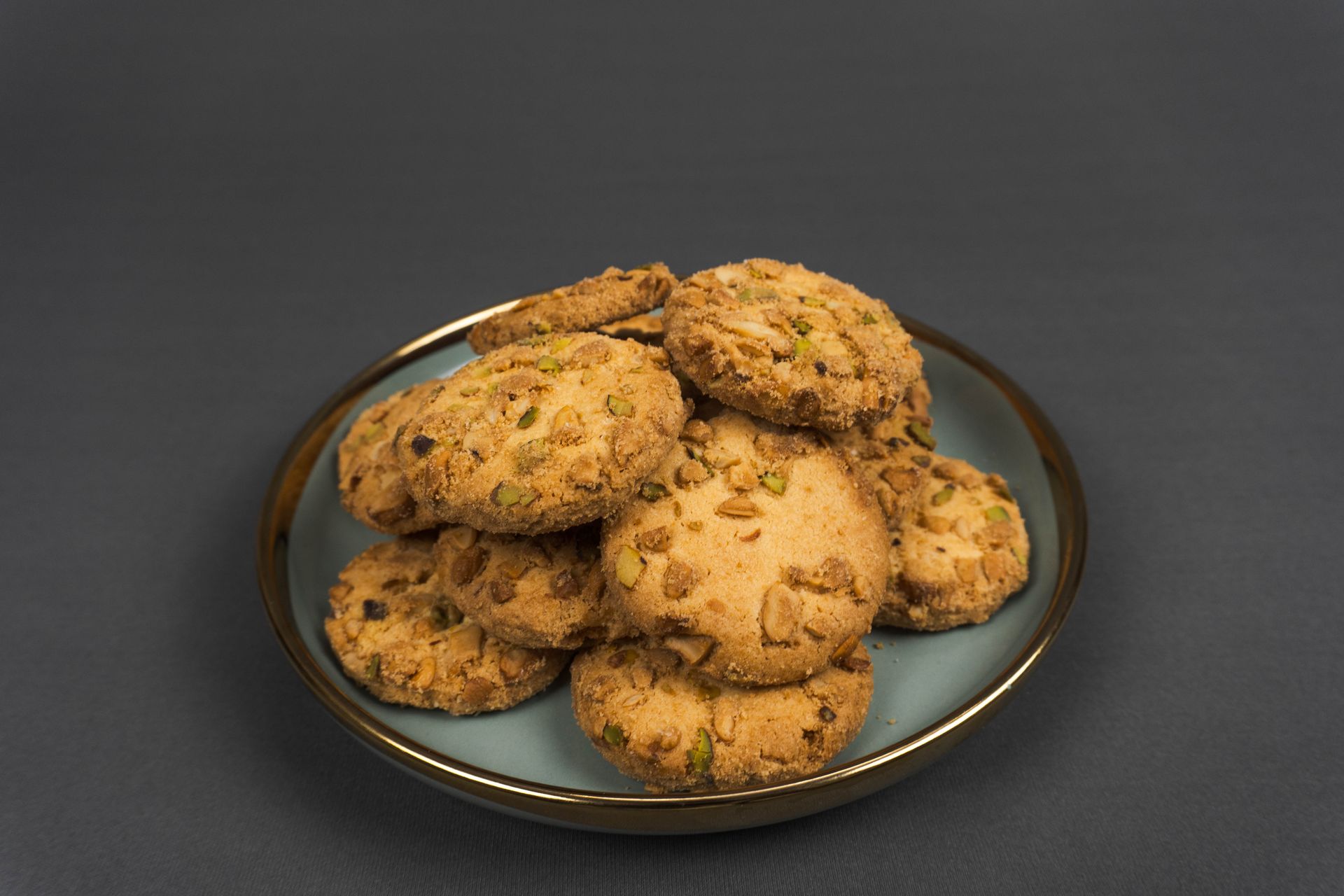 Golden almond cookies in a dark bowl