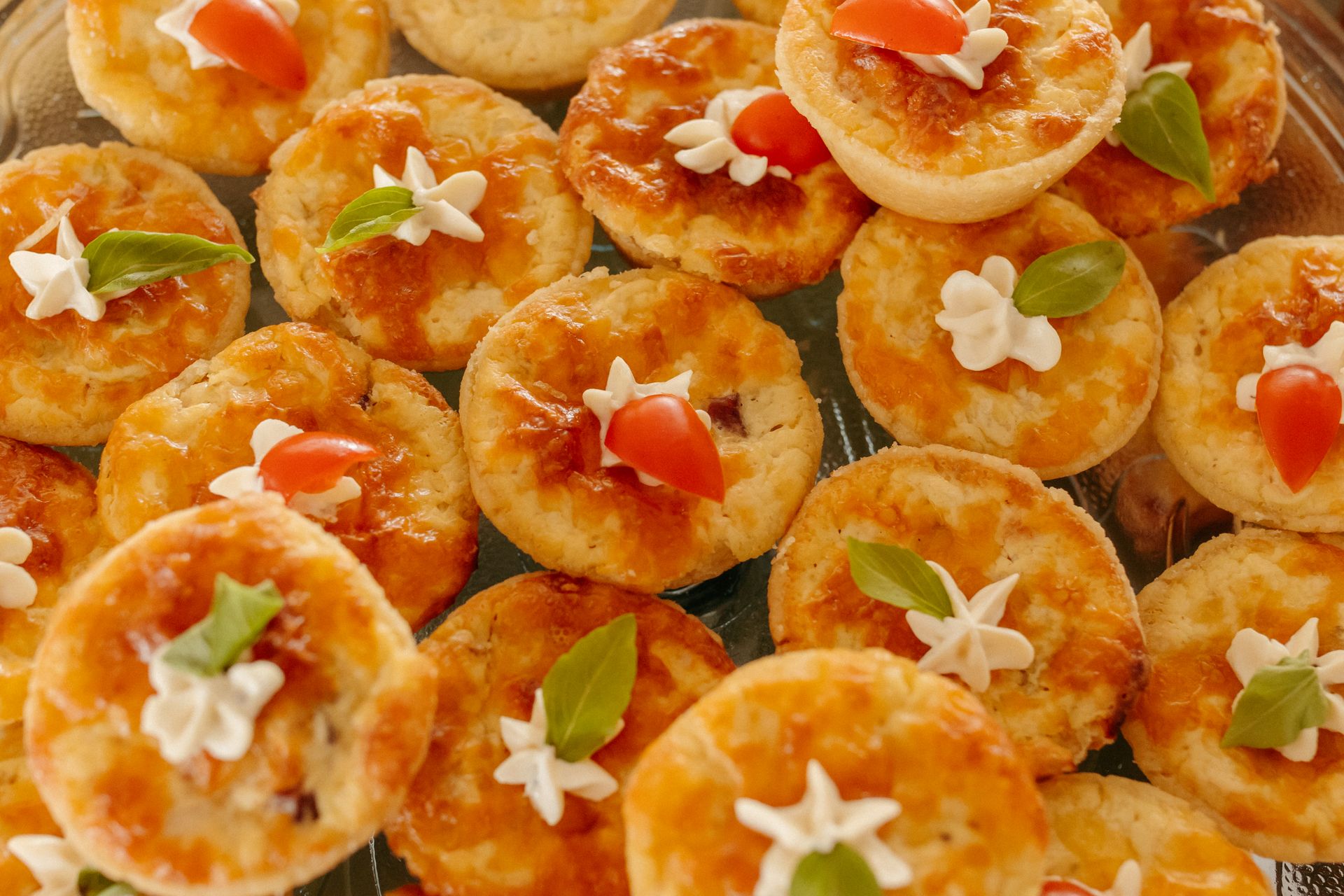Mini quiches with tomato on a tray
