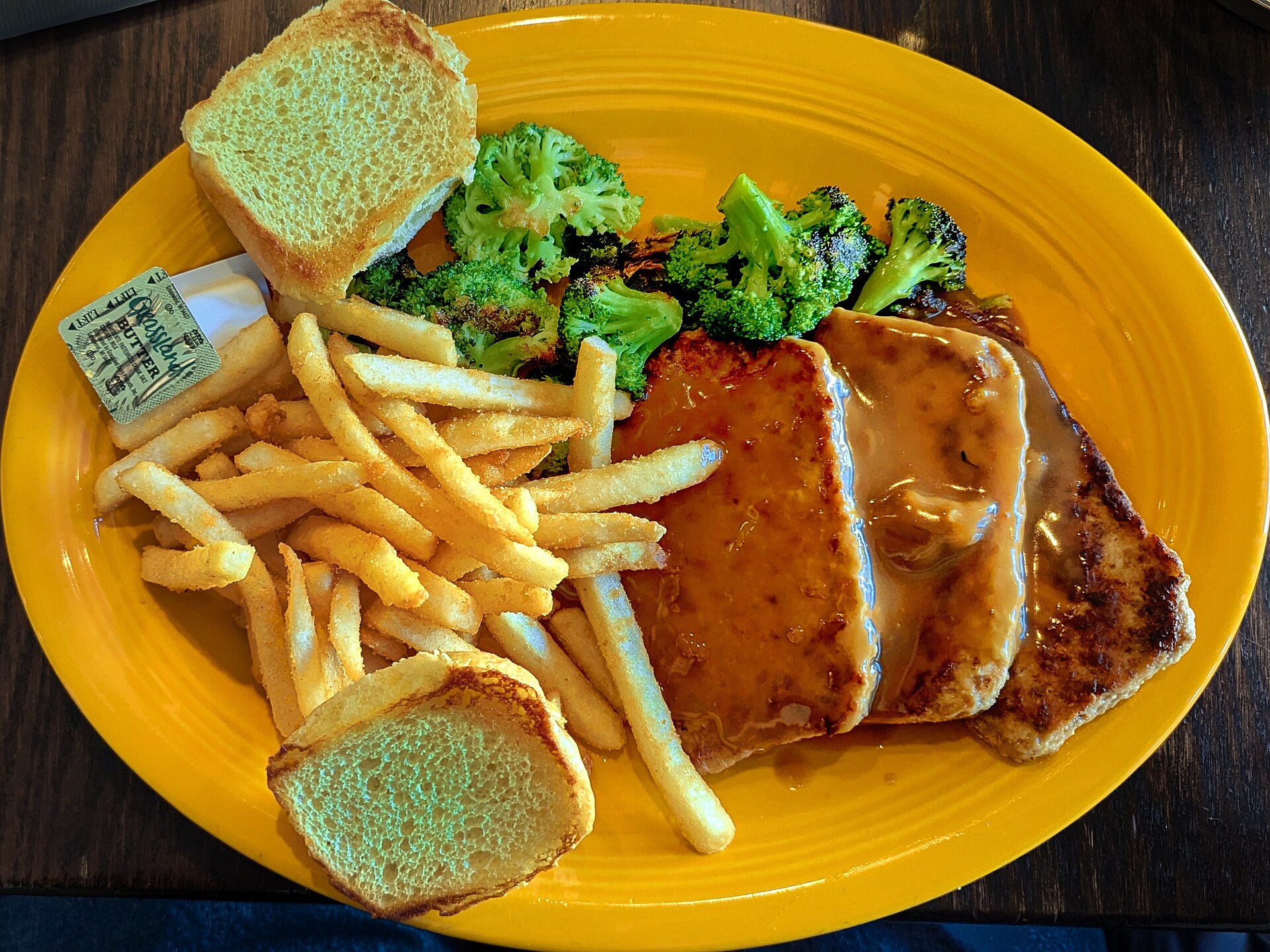 Stuffing mix recipes: meatloaf slices with gravy and fries on a plate