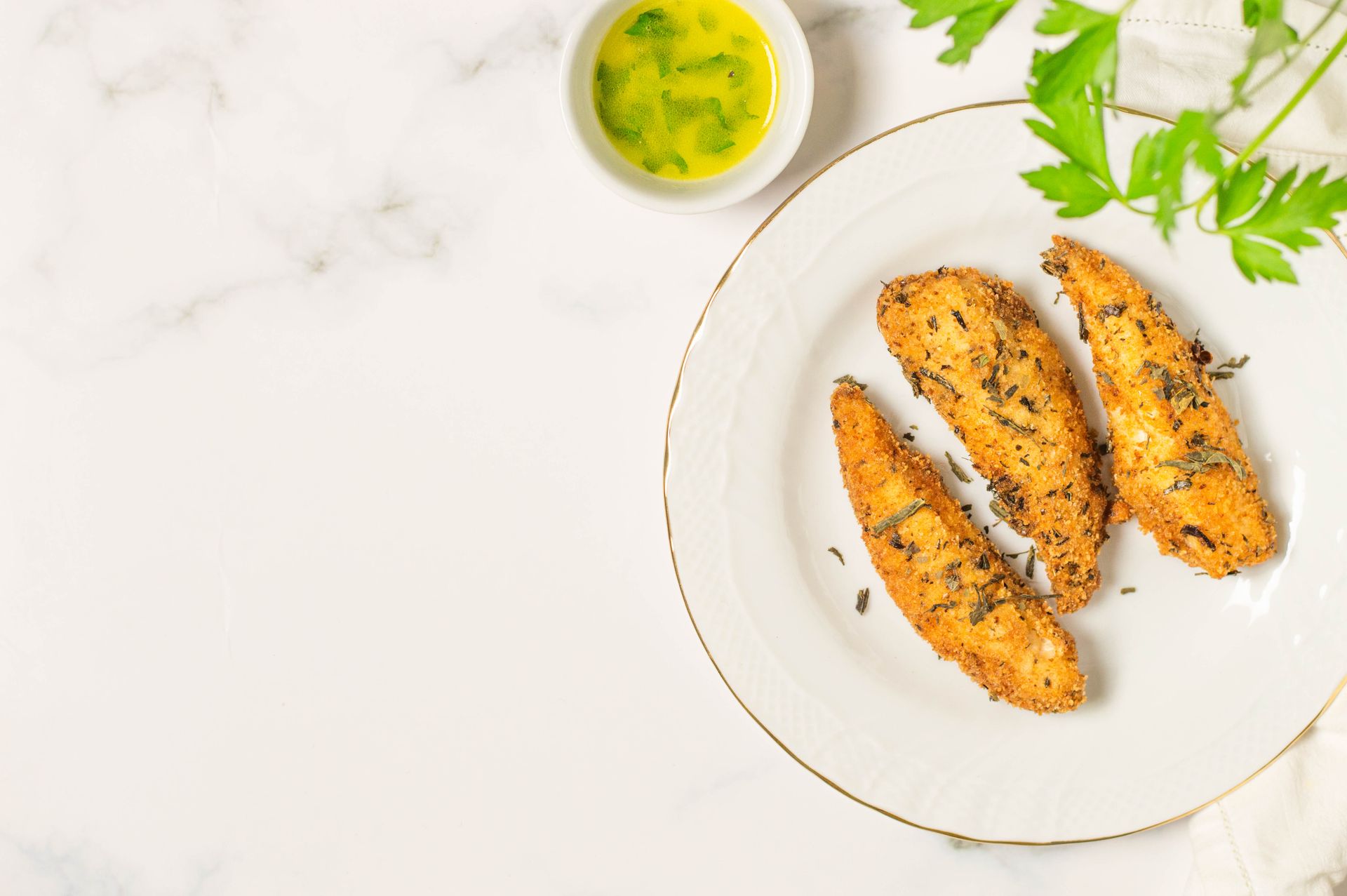 Stuffing mix recipes: crispy crusted chicken tenders on a white plate