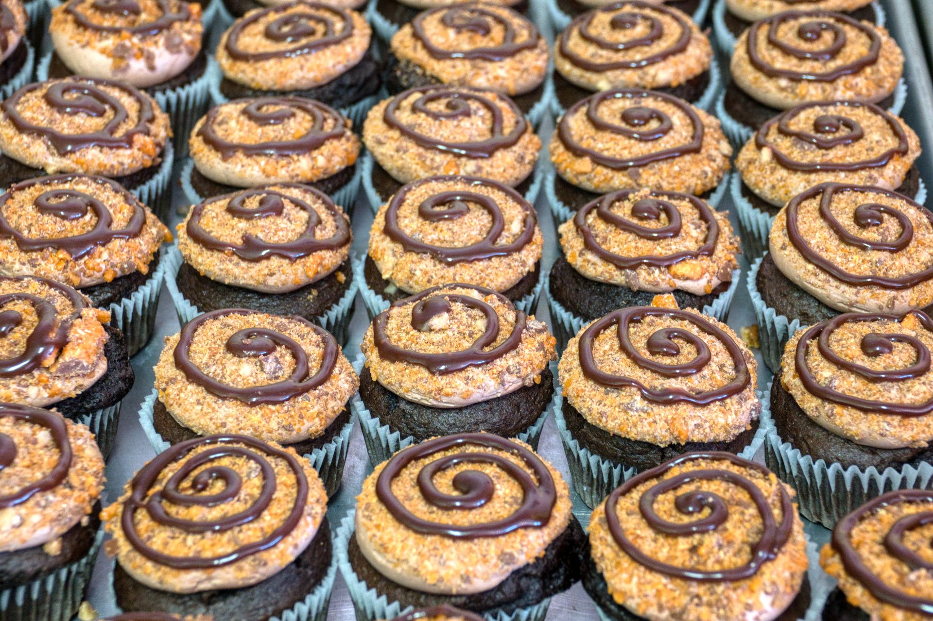 Cupcakes with swirls of frosting on a tray