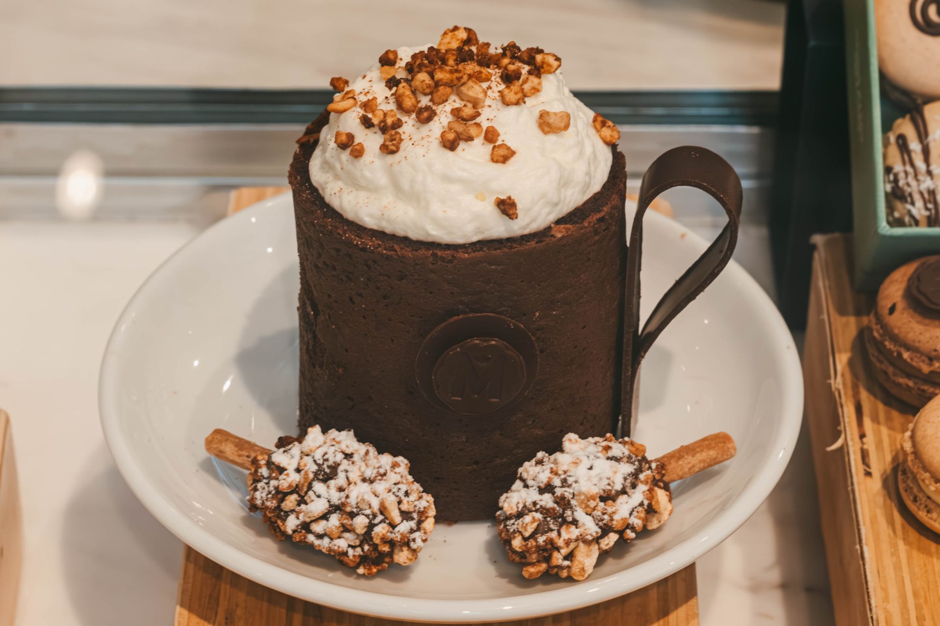 Sticky toffee pudding in a mug topped with whipped cream