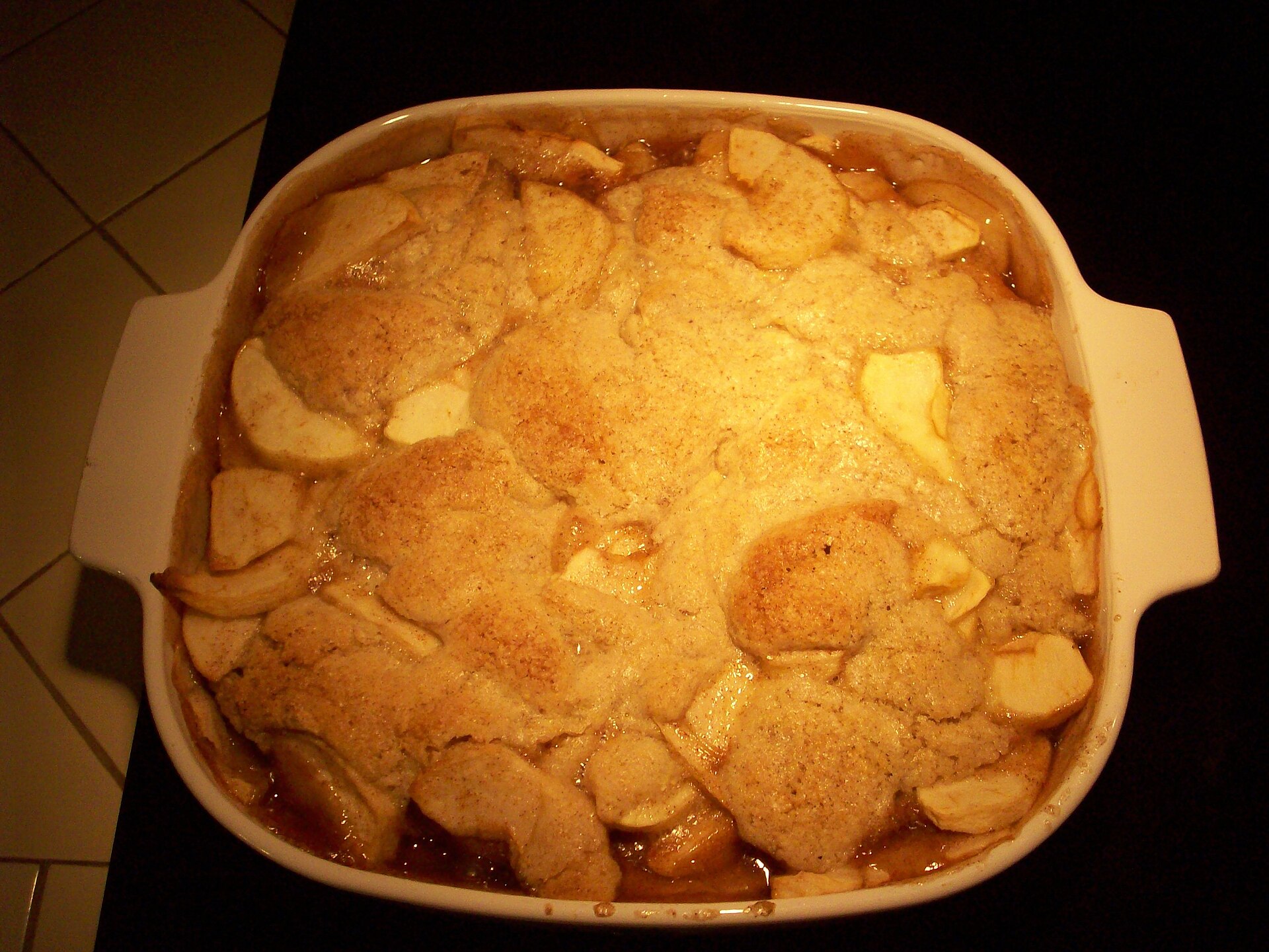 Baked apple cobbler in a white dish