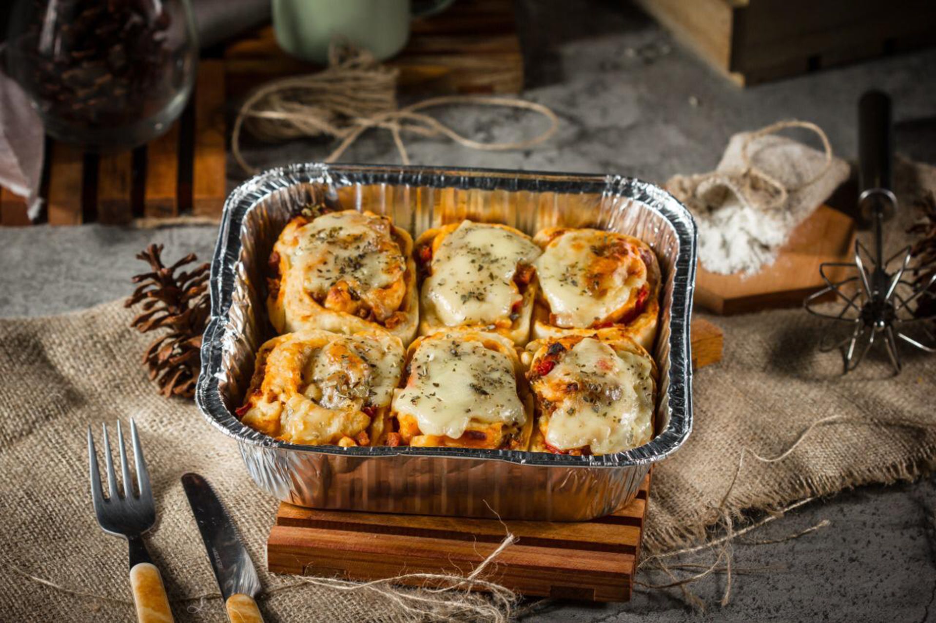 Lasagna roll-ups baked in a foil pan