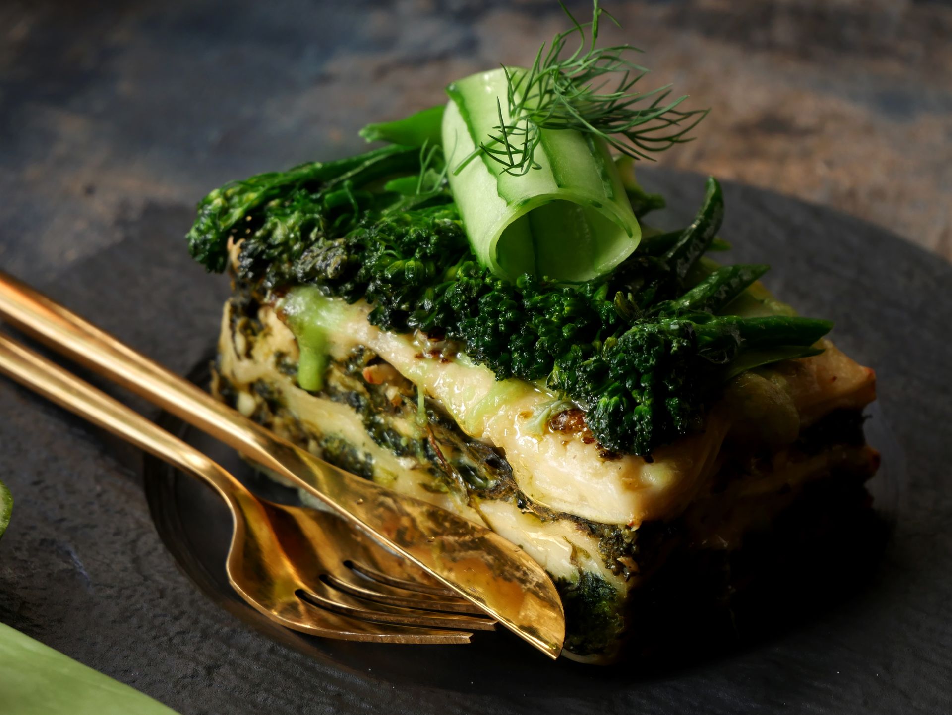 Spinach and cheese lasagna slice with fresh greens
