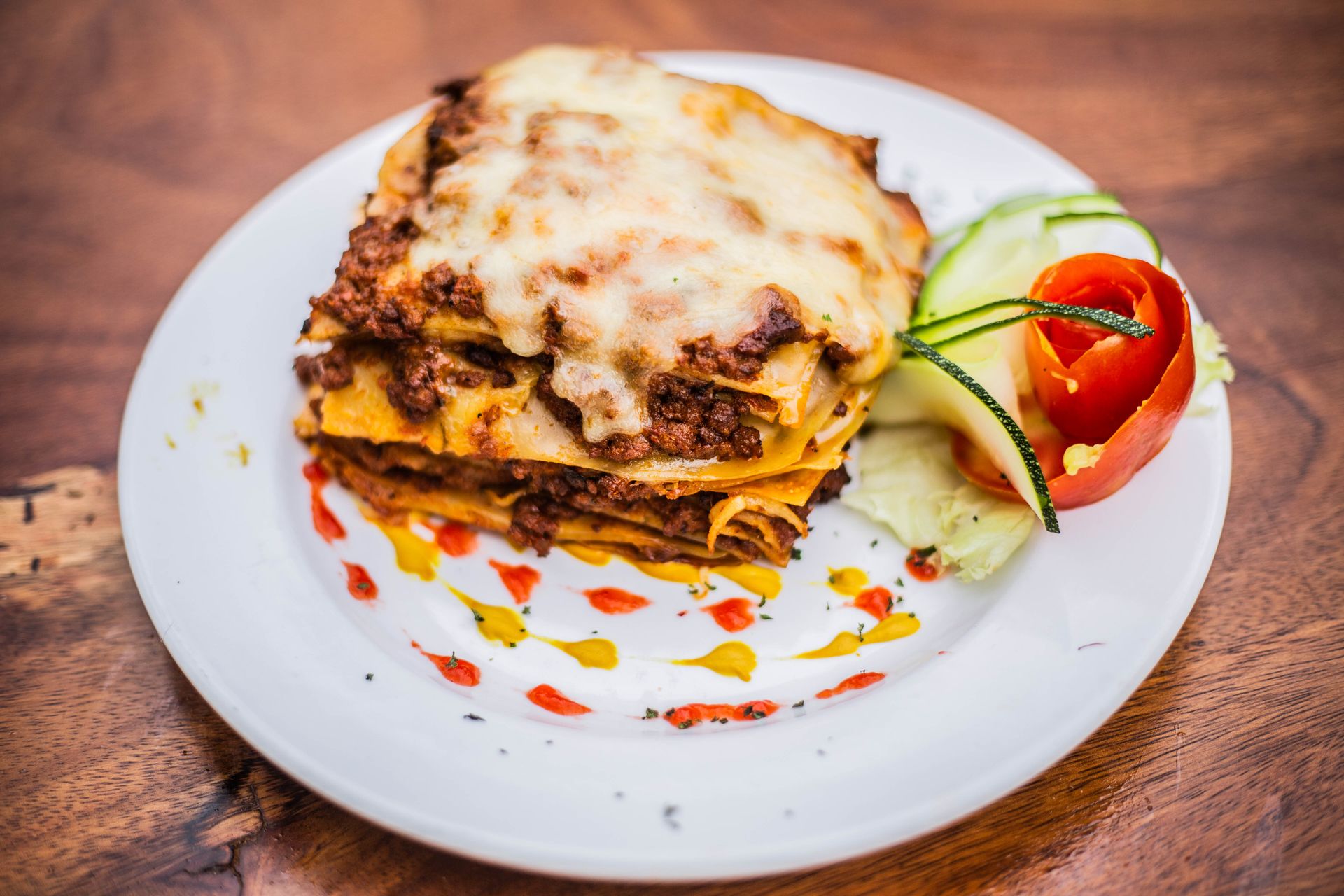 Layered meat lasagna slice on a white plate