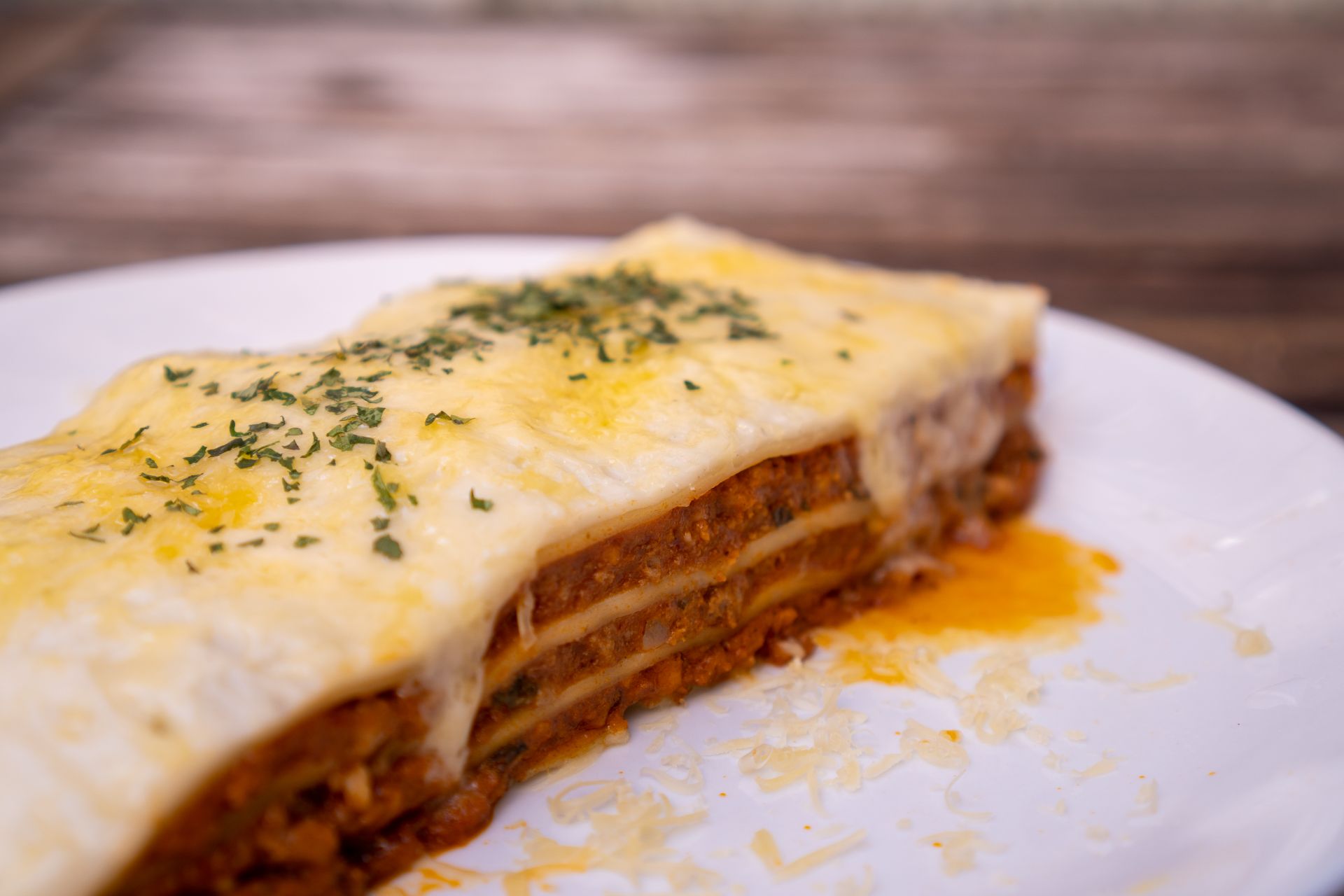 Slice of lasagna with a creamy white cheese top