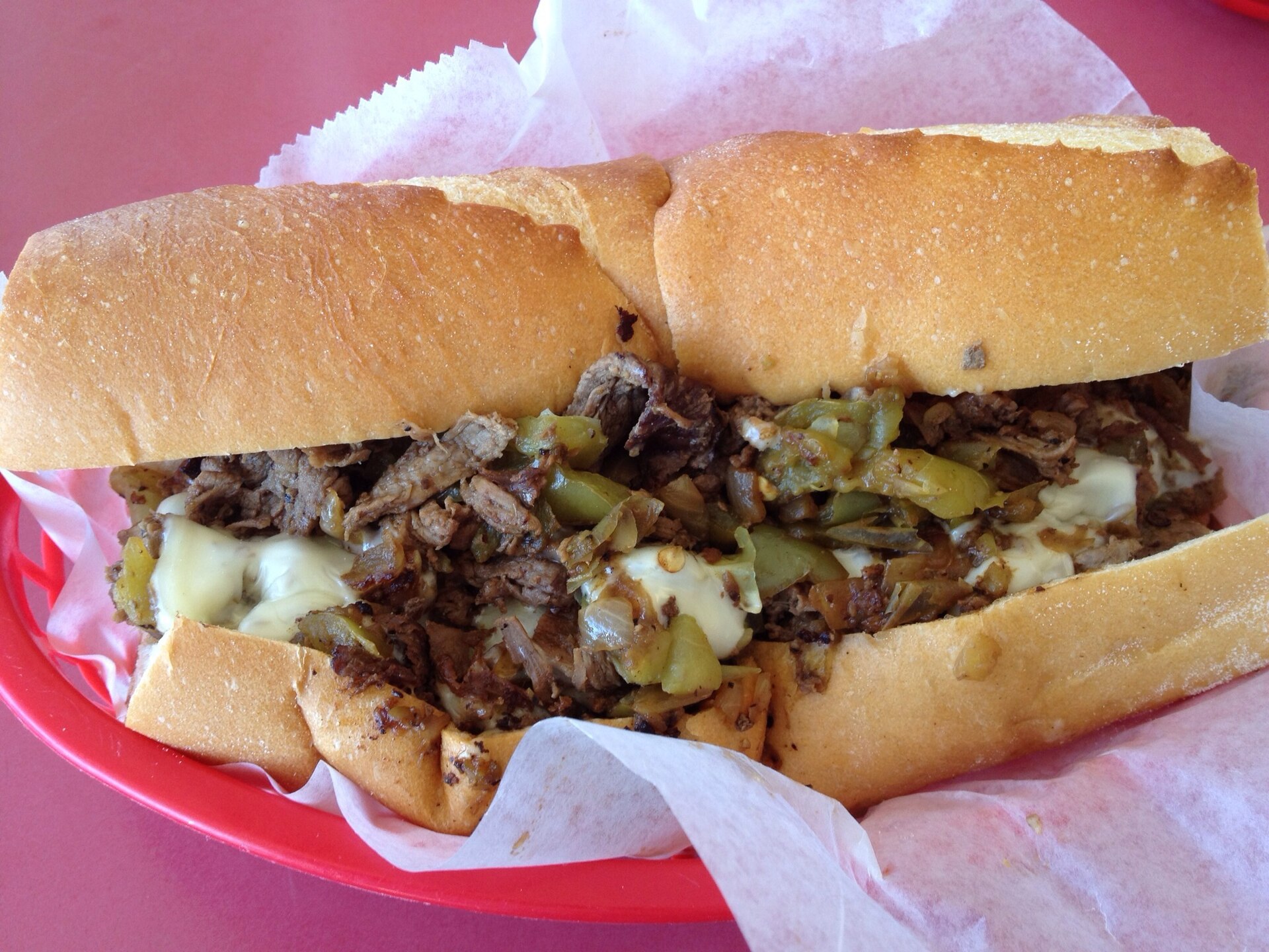 Cheesesteak style sandwich with peppers, onions and melted cheese